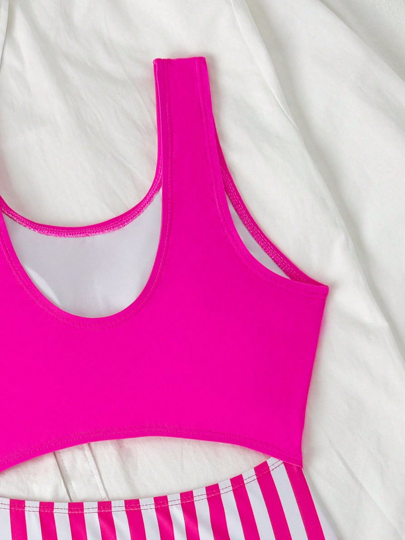 Purple tween girls one-piece swimsuit with asymmetrical neckline, cut-out waist, striped pattern, fitted silhouette, and lined body.