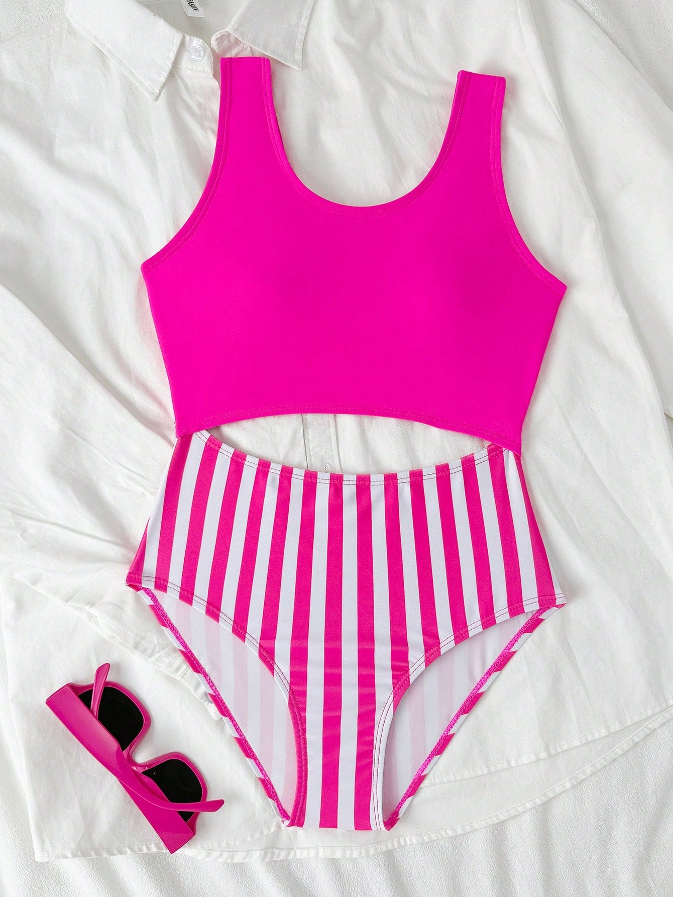 Purple tween girls one-piece swimsuit with asymmetrical neckline, cut-out waist, striped pattern, fitted silhouette, and lined body.