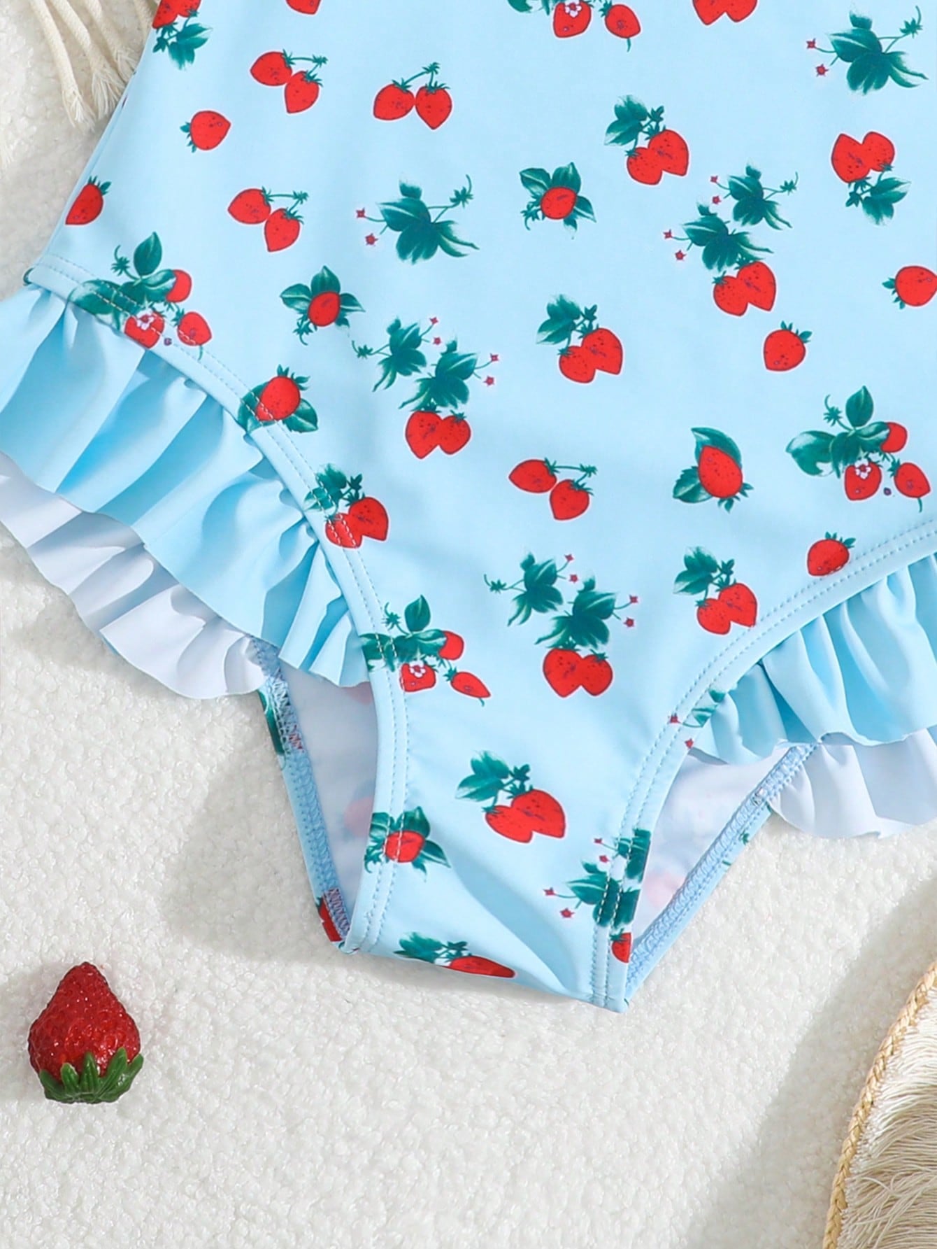 Tween girl plaid all-over print one-piece swimsuit with ruffle detail, spaghetti straps, fitted shape, and multicolor patchwork style for beach or pool wear.