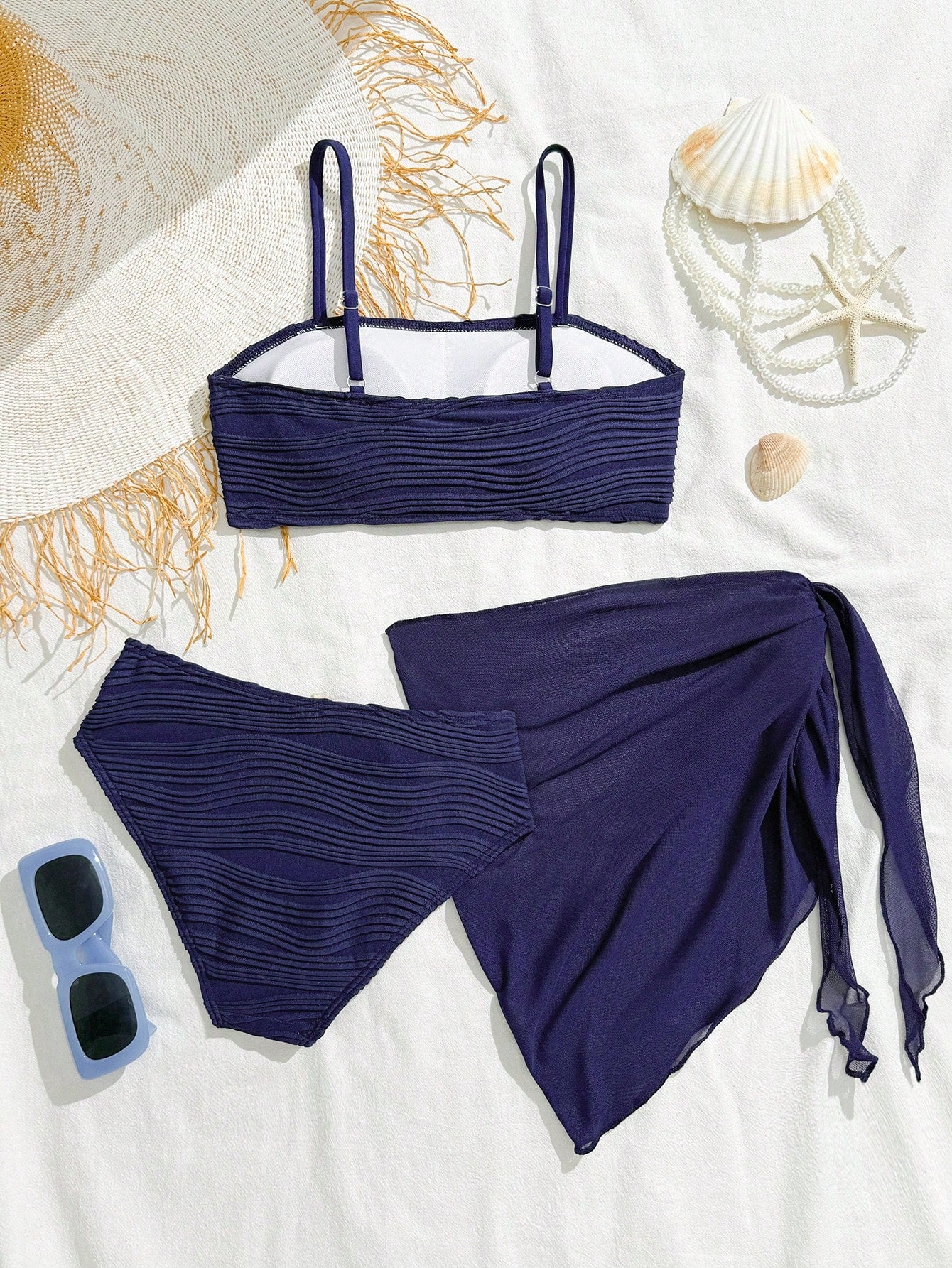 Tween girls bikini set with shell and starfish woven band details, spaghetti strap sleeveless top, and mid-waist skirt-style bottom in blue.