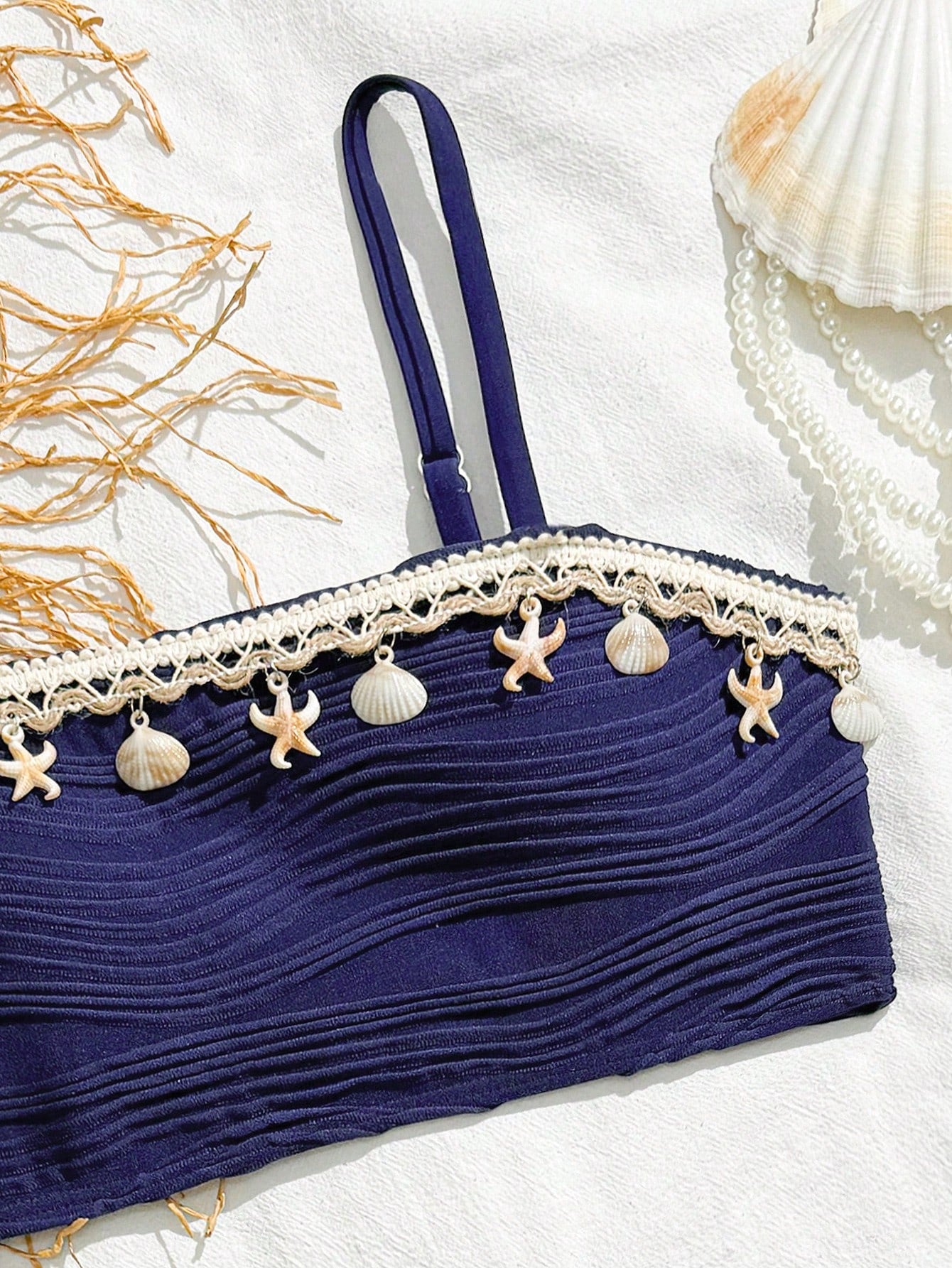 Tween girls bikini set with shell and starfish woven band details, spaghetti strap sleeveless top, and mid-waist skirt-style bottom in blue.
