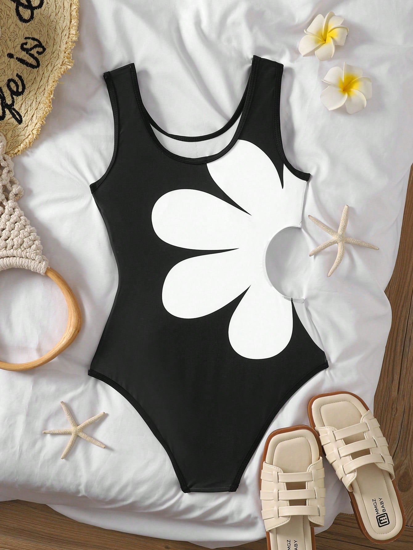 Tween girls' black and white one-piece swimsuit with striped patchwork design, scoop neck, asymmetrical cut-out detail, and fitted vacation swimwear style.