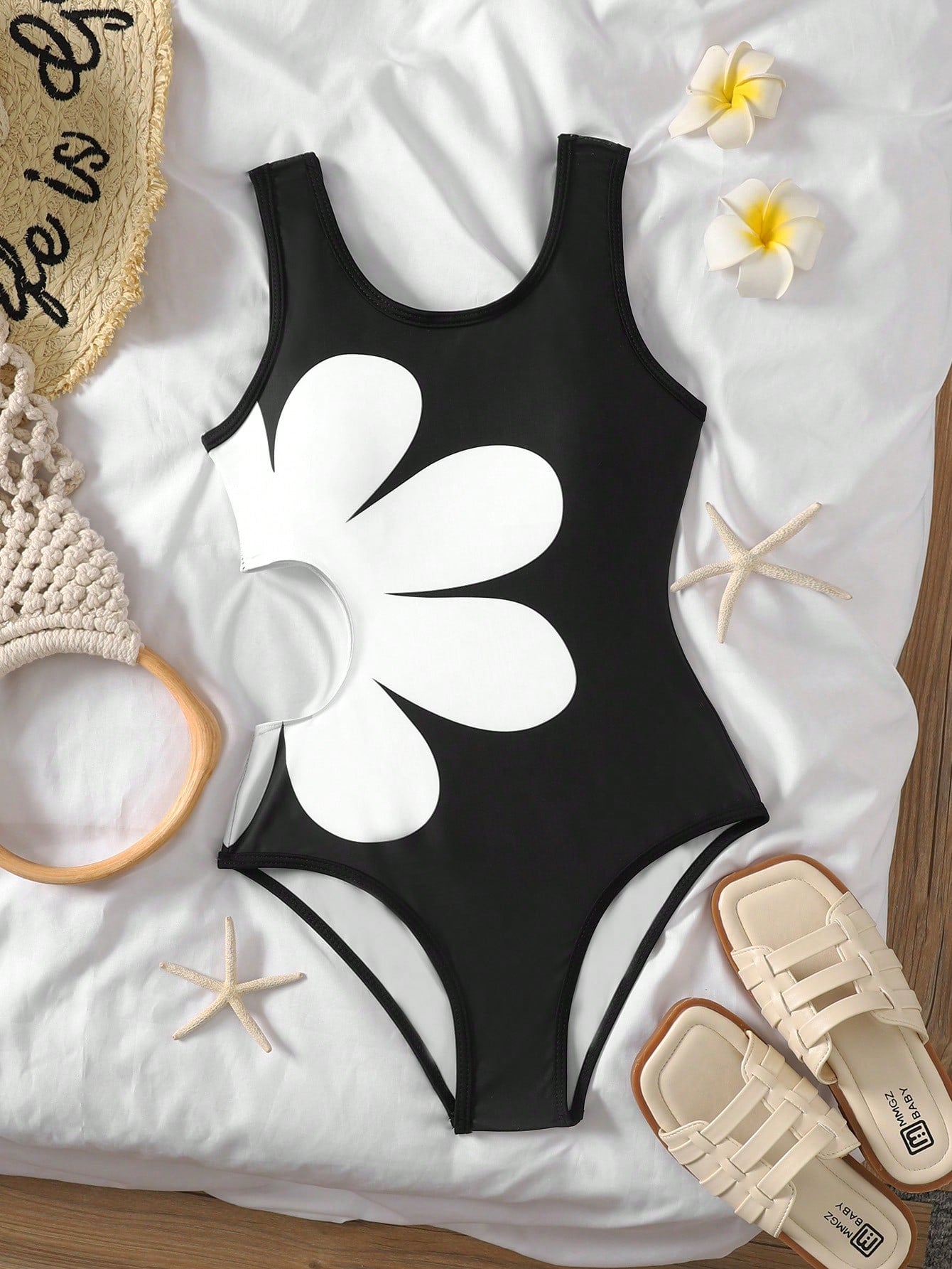 Tween girls' black and white one-piece swimsuit with striped patchwork design, scoop neck, asymmetrical cut-out detail, and fitted vacation swimwear style.
