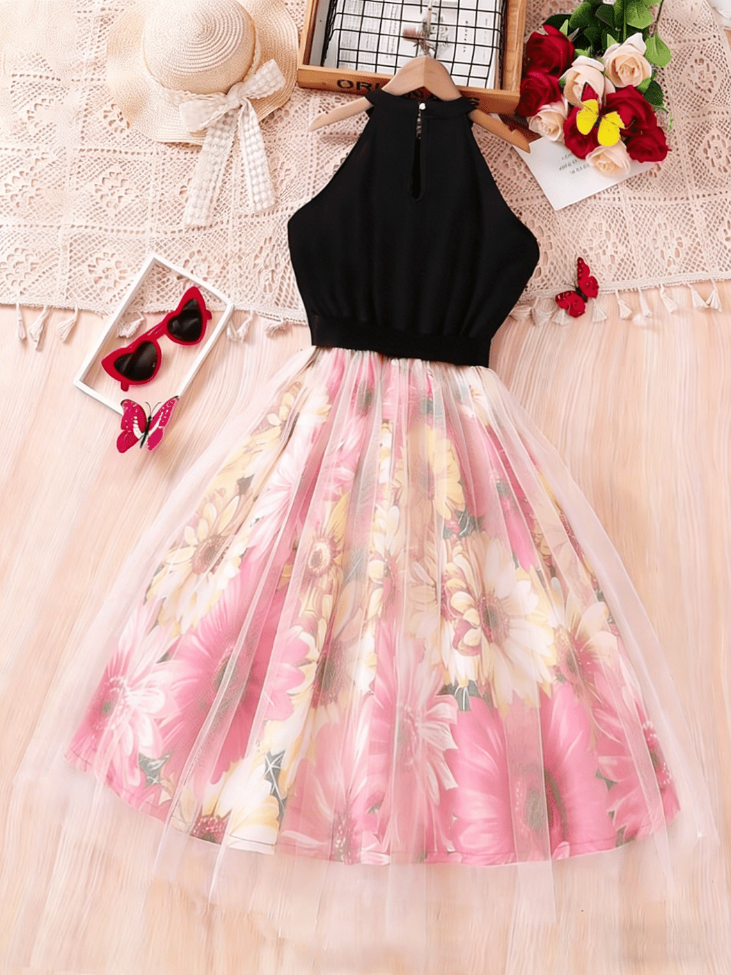 Tween girls black halter neck A-line dress featuring contrast mesh skirt with embroidery, high waist belted design, and flared long hem.
