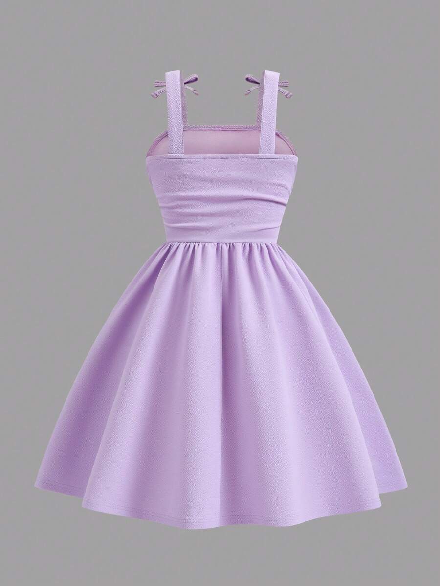 Tween girl wearing a purple sleeveless striped cami mini dress featuring a high waist flared hem and beaded pearl details.
