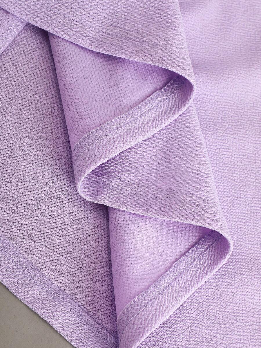 Tween girl wearing a purple sleeveless striped cami mini dress featuring a high waist flared hem and beaded pearl details.
