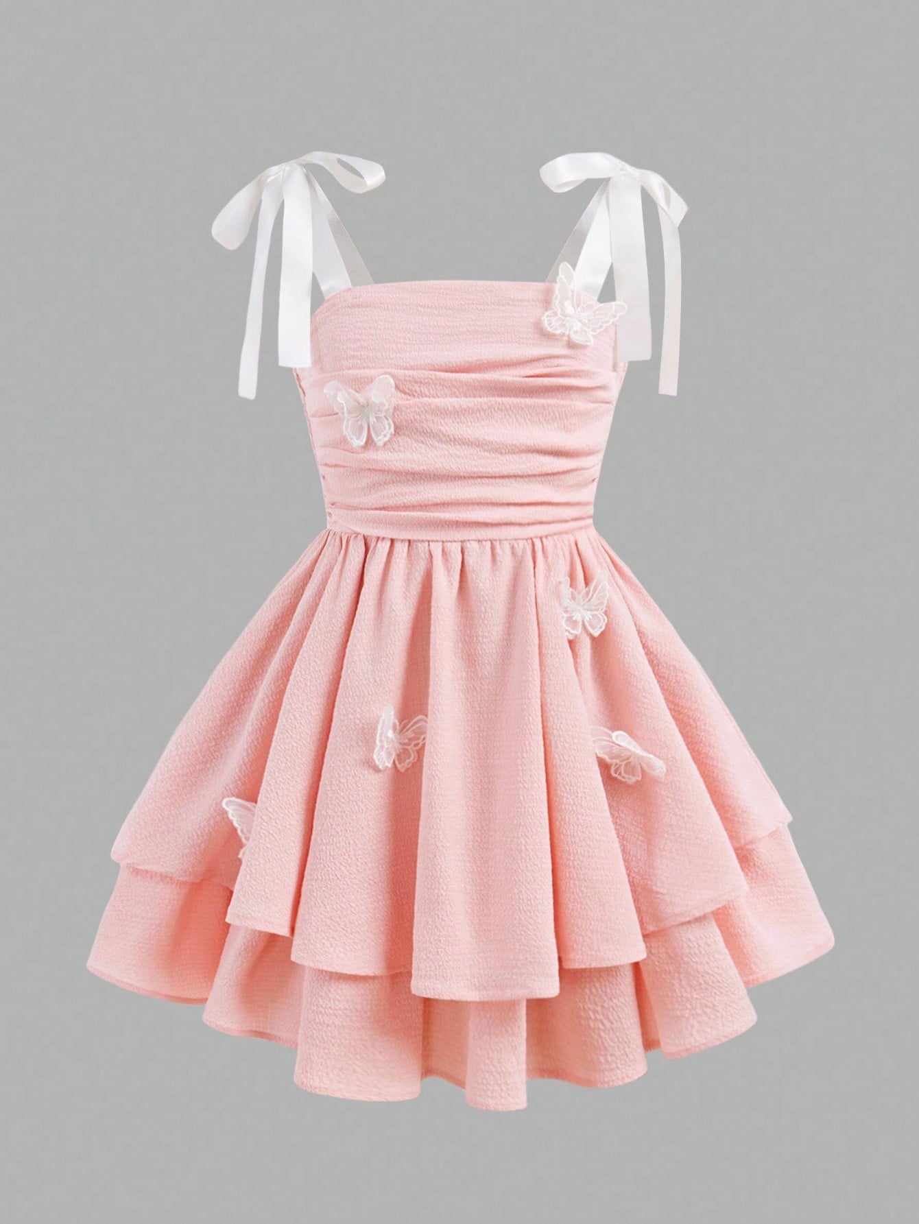 Tween girls apricot tiered cami dress with spaghetti straps, high waist, and slim fit layered hem.
