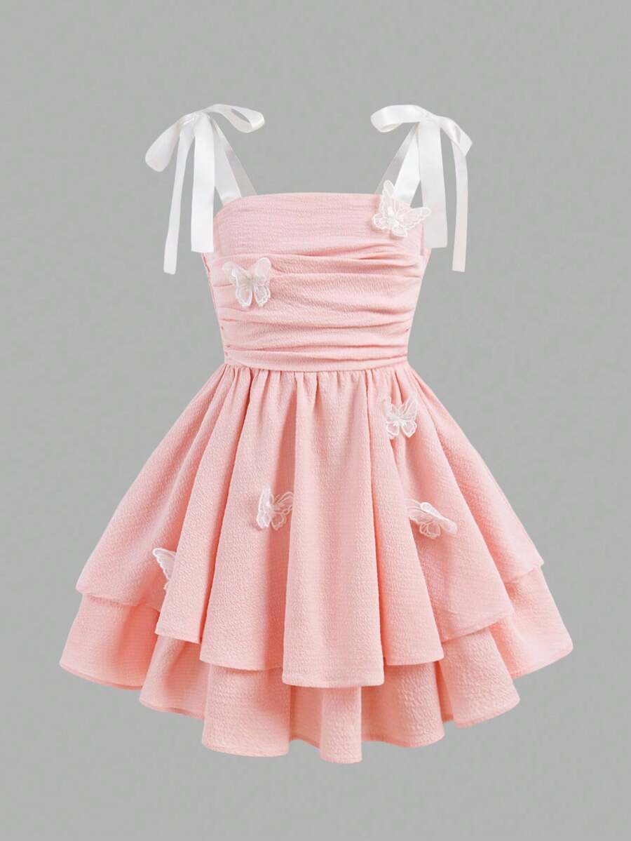 Tween girls apricot tiered cami dress with spaghetti straps, high waist, and slim fit layered hem.