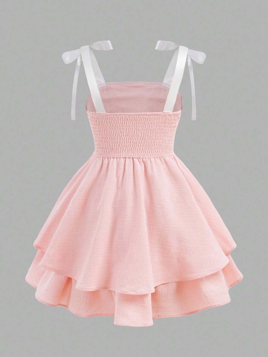 Tween girls apricot tiered cami dress with spaghetti straps, high waist, and slim fit layered hem.