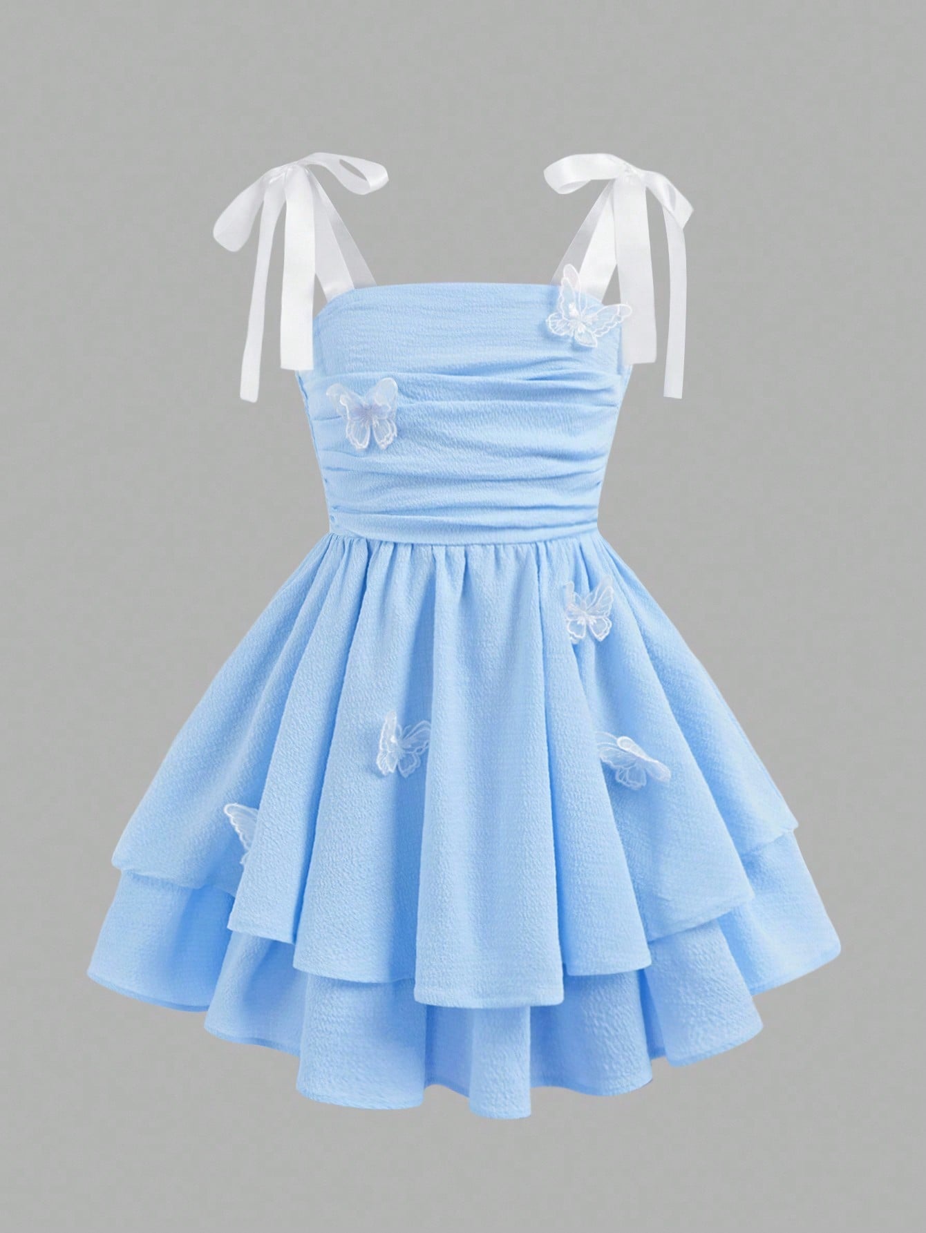 Tween girls apricot tiered cami dress with spaghetti straps, high waist, and slim fit layered hem.