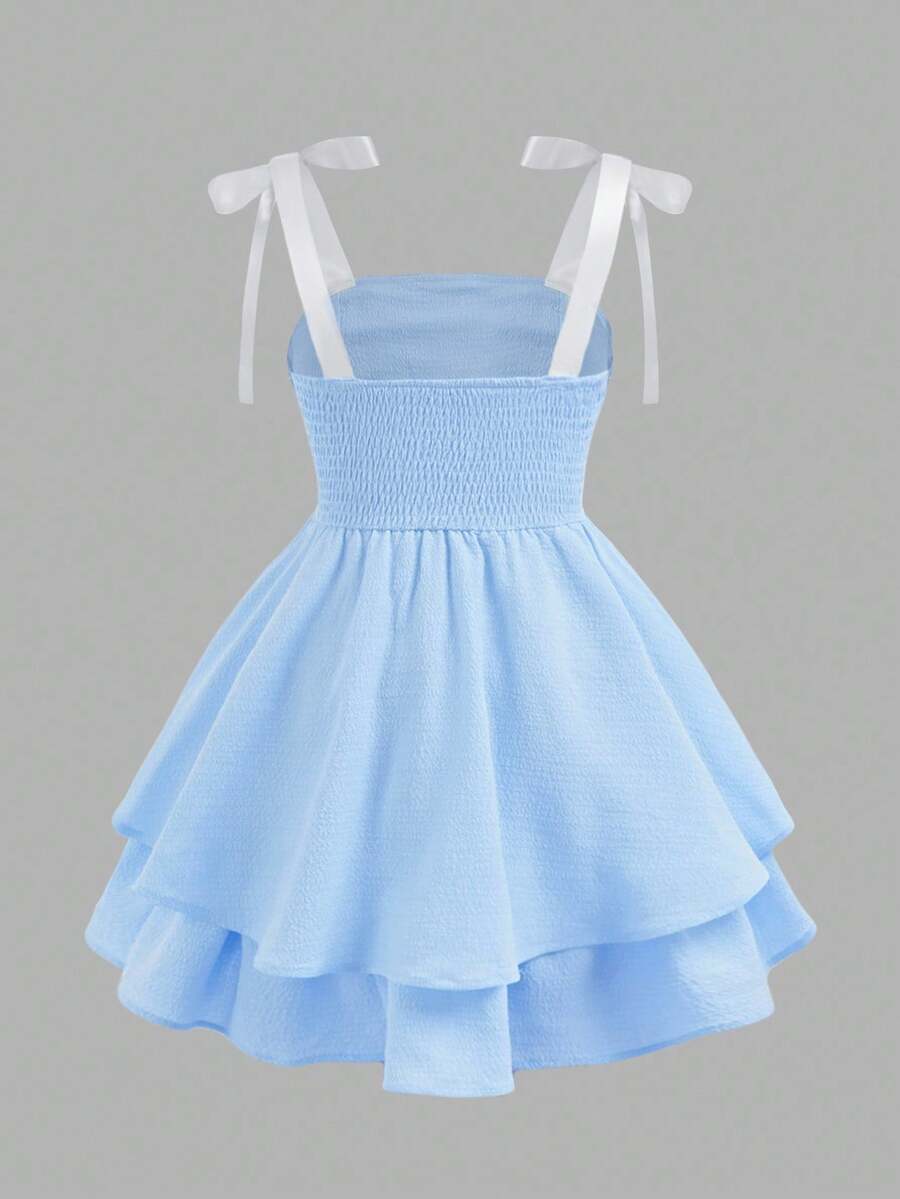 Tween girls apricot tiered cami dress with spaghetti straps, high waist, and slim fit layered hem.