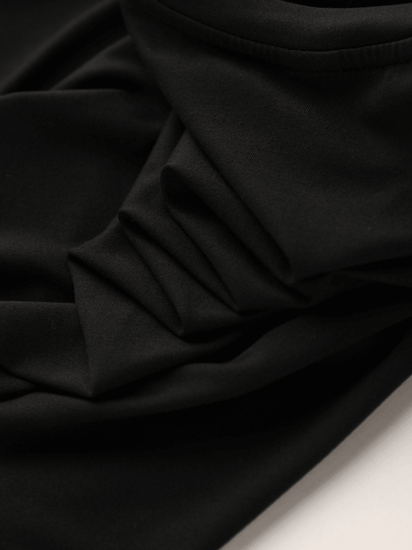 Girls black ruffle sleeve midi dress featuring a loose fit tunic silhouette, round neckline, button details, and short flounce sleeves.
