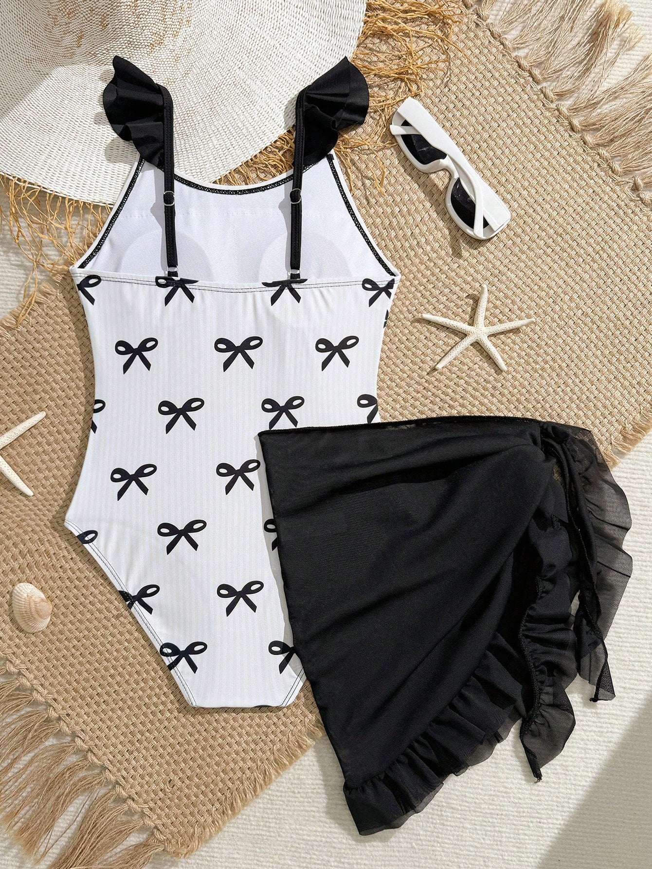 Tween girls one-piece swimsuit in leopard print with ruffle shoulder straps, scoop neckline, fitted shape, and attached ruffle hem skirt; sleeveless, mid-waist skirt bottom, and lined body for swimming, vacation, and summer beach wear.