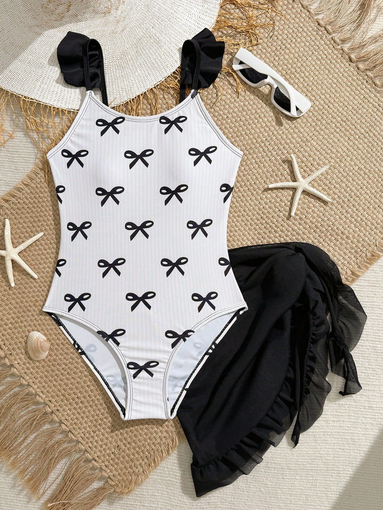 Tween girls one-piece swimsuit in leopard print with ruffle shoulder straps, scoop neckline, fitted shape, and attached ruffle hem skirt; sleeveless, mid-waist skirt bottom, and lined body for swimming, vacation, and summer beach wear.