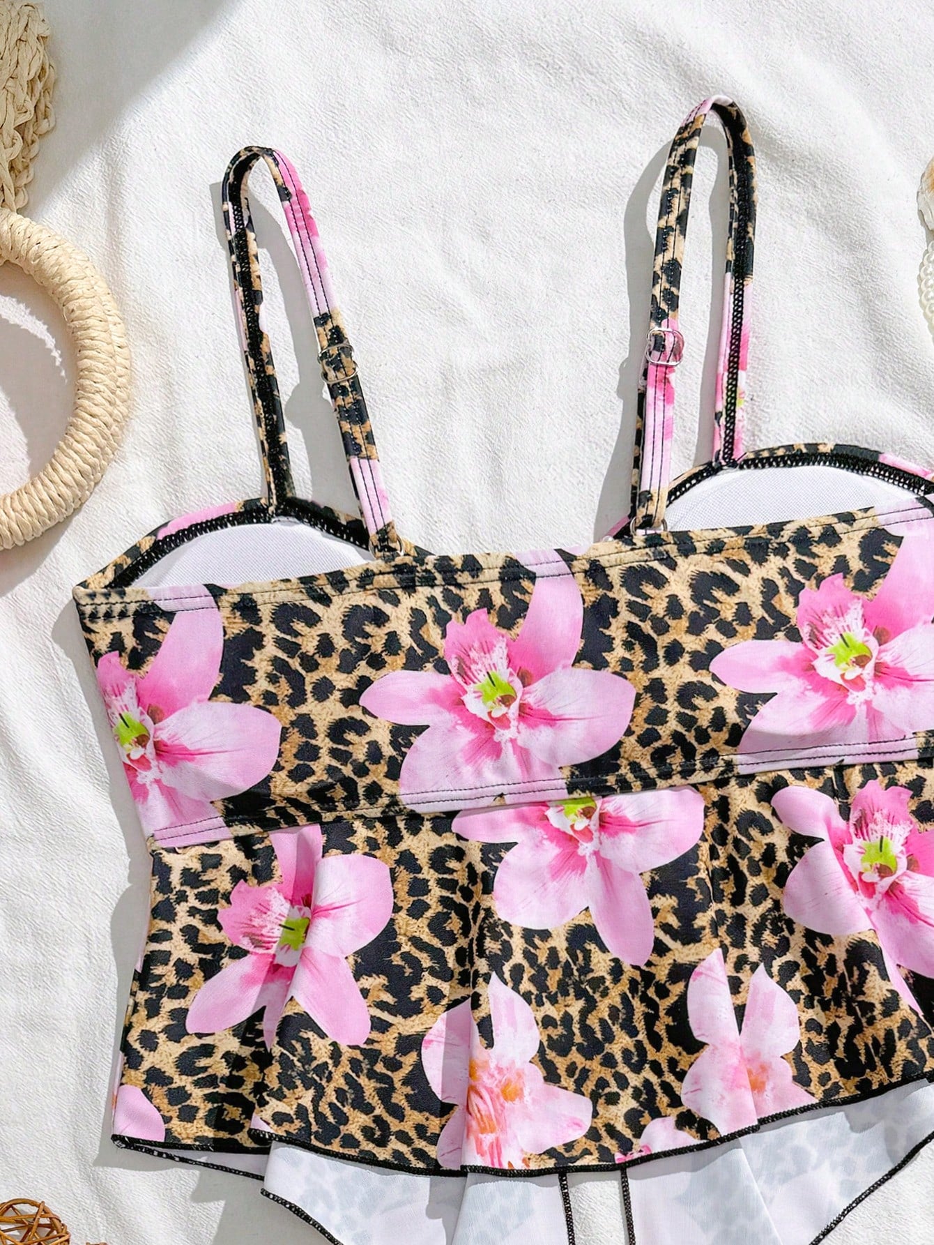 Tween girls two-piece tankini swimwear set with spaghetti straps, asymmetrical design, and 3D rose detail. Features a plant-pattern top and mid-waist bottoms in stretchy fabric for beach or pool wear.