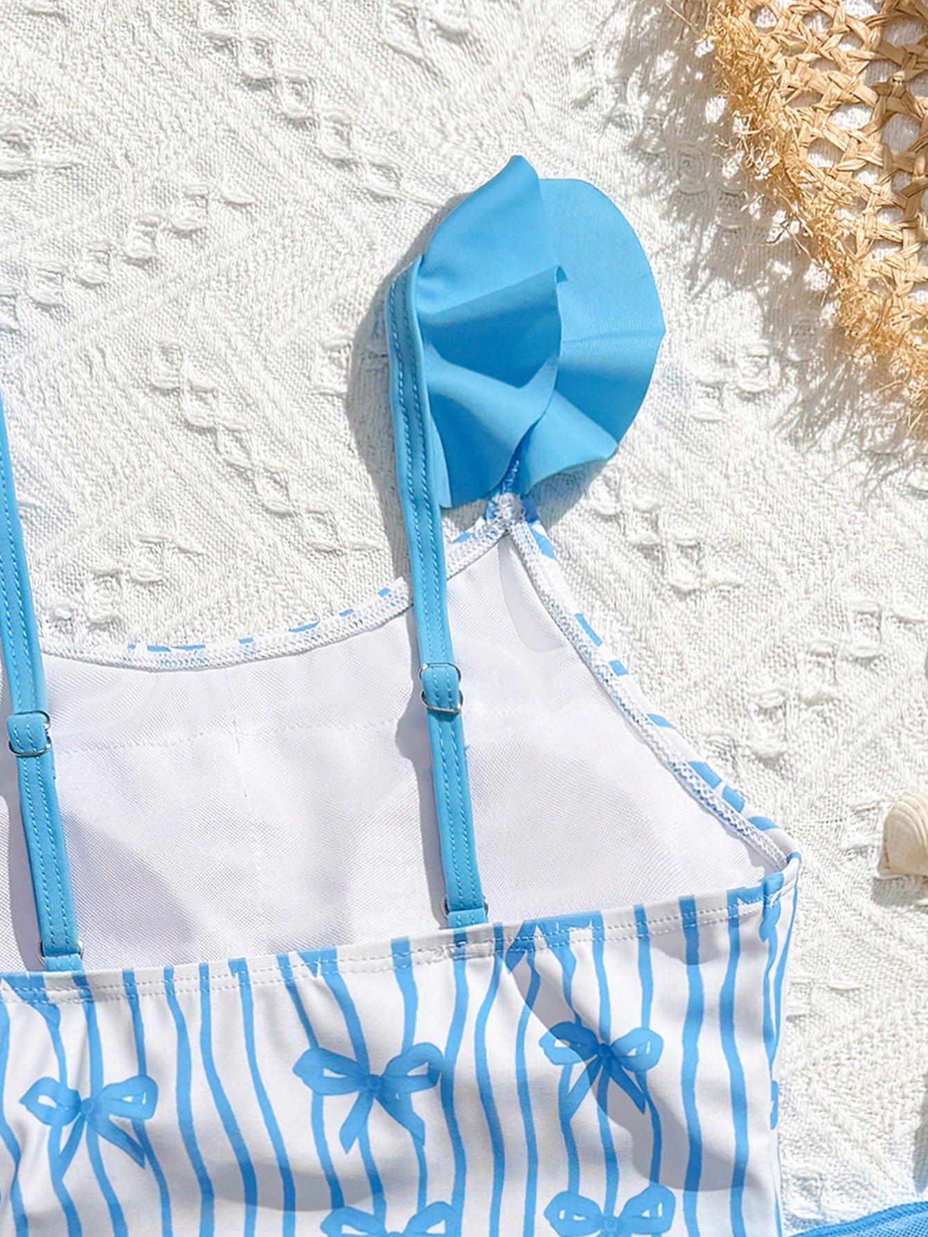 Tween girls one-piece swimsuit in leopard print with ruffle shoulder straps, scoop neckline, fitted shape, and attached ruffle hem skirt; sleeveless, mid-waist skirt bottom, and lined body for swimming, vacation, and summer beach wear.