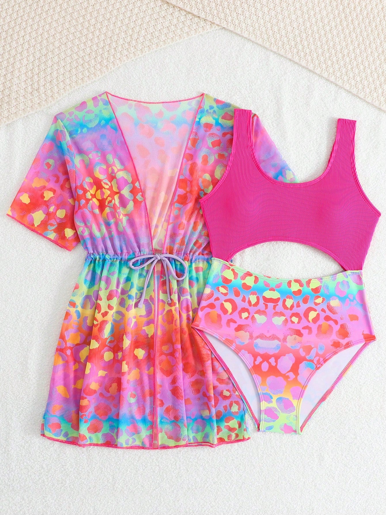 Tween girls multicolor 2-piece swimsuit set with scoop neck, cut-out details, patterned design, shorts-style bottoms, and sheer UV protection cover-up for beach and pool vacations.