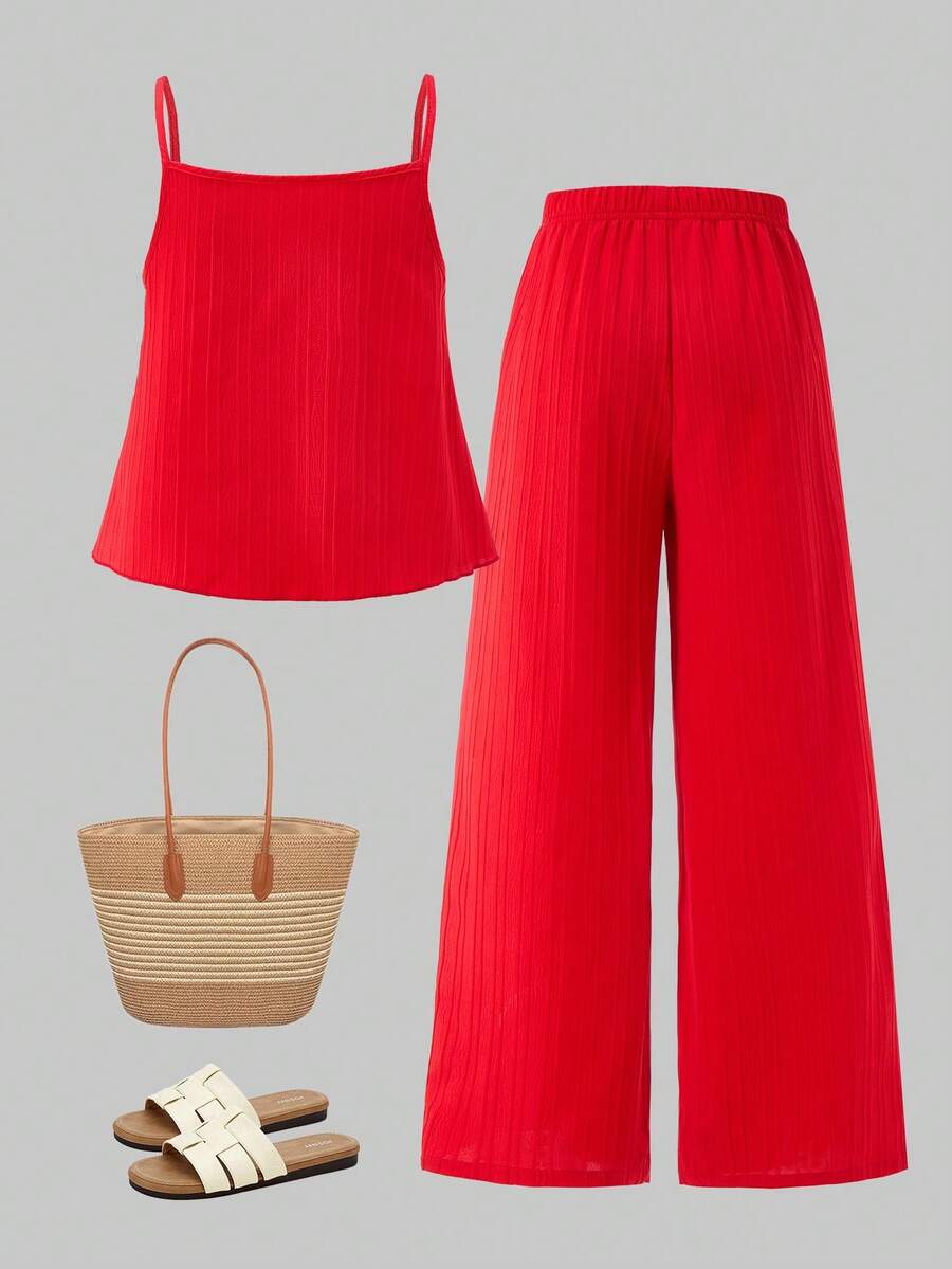 Tween girl wearing an apricot 2-piece outfit set featuring a shirred spaghetti strap short cami top and matching wide-leg long pants.