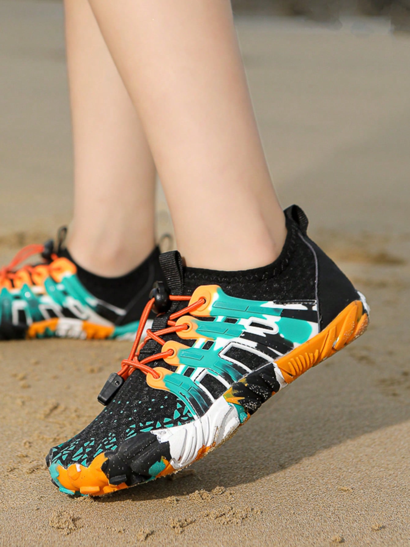 Apricot children's water shoes featuring slip-on fabric uppers, drawstring details, and rubber soles for beach play.