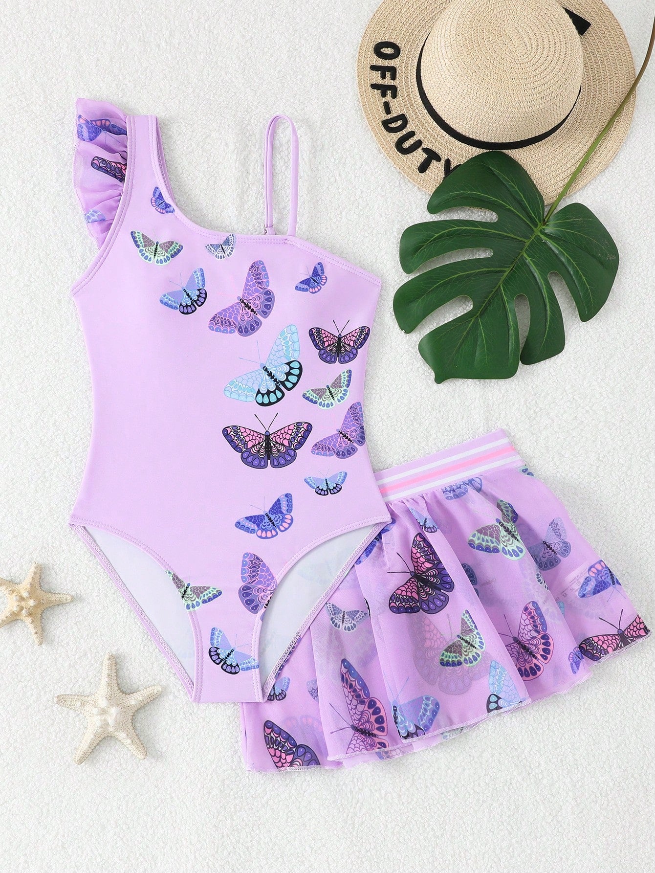 Girls yellow one-piece swimsuit with asymmetrical neckline, ruffle detail, sleeveless fitted style, and skirt bottom for beach and pool vacations.
