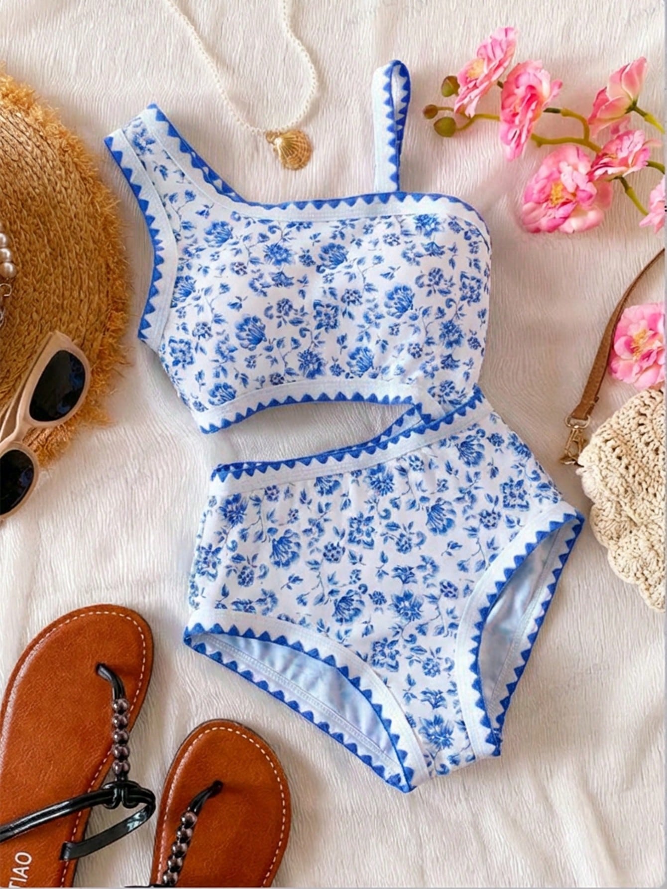 Tween girls one-piece swimsuit featuring an asymmetric neckline, pendant decor, plain design, wireless bra, high-cut bottom, and medium-stretch fabric.