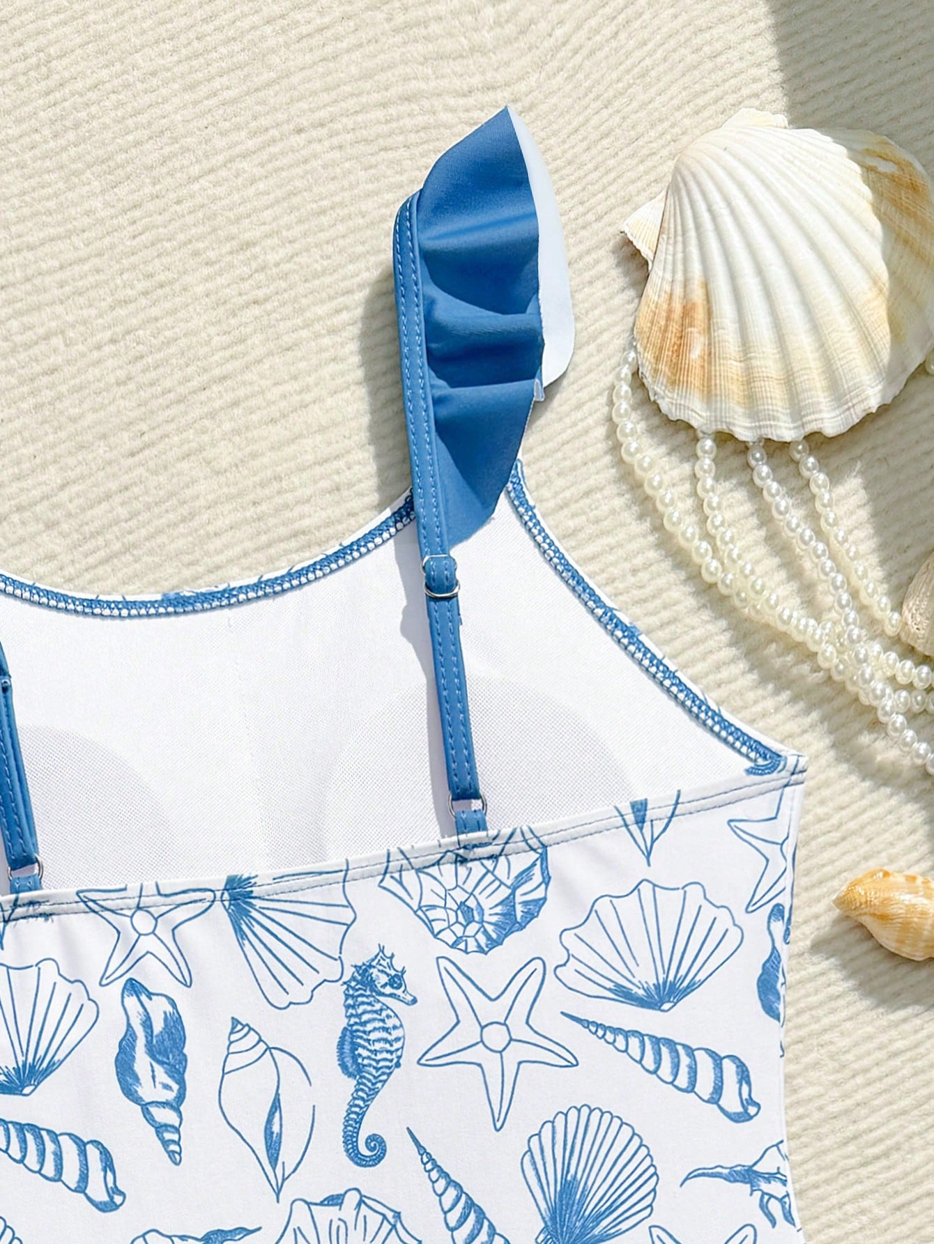 Tween girls one-piece swimsuit in leopard print with ruffle shoulder straps, scoop neckline, fitted shape, and attached ruffle hem skirt; sleeveless, mid-waist skirt bottom, and lined body for swimming, vacation, and summer beach wear.