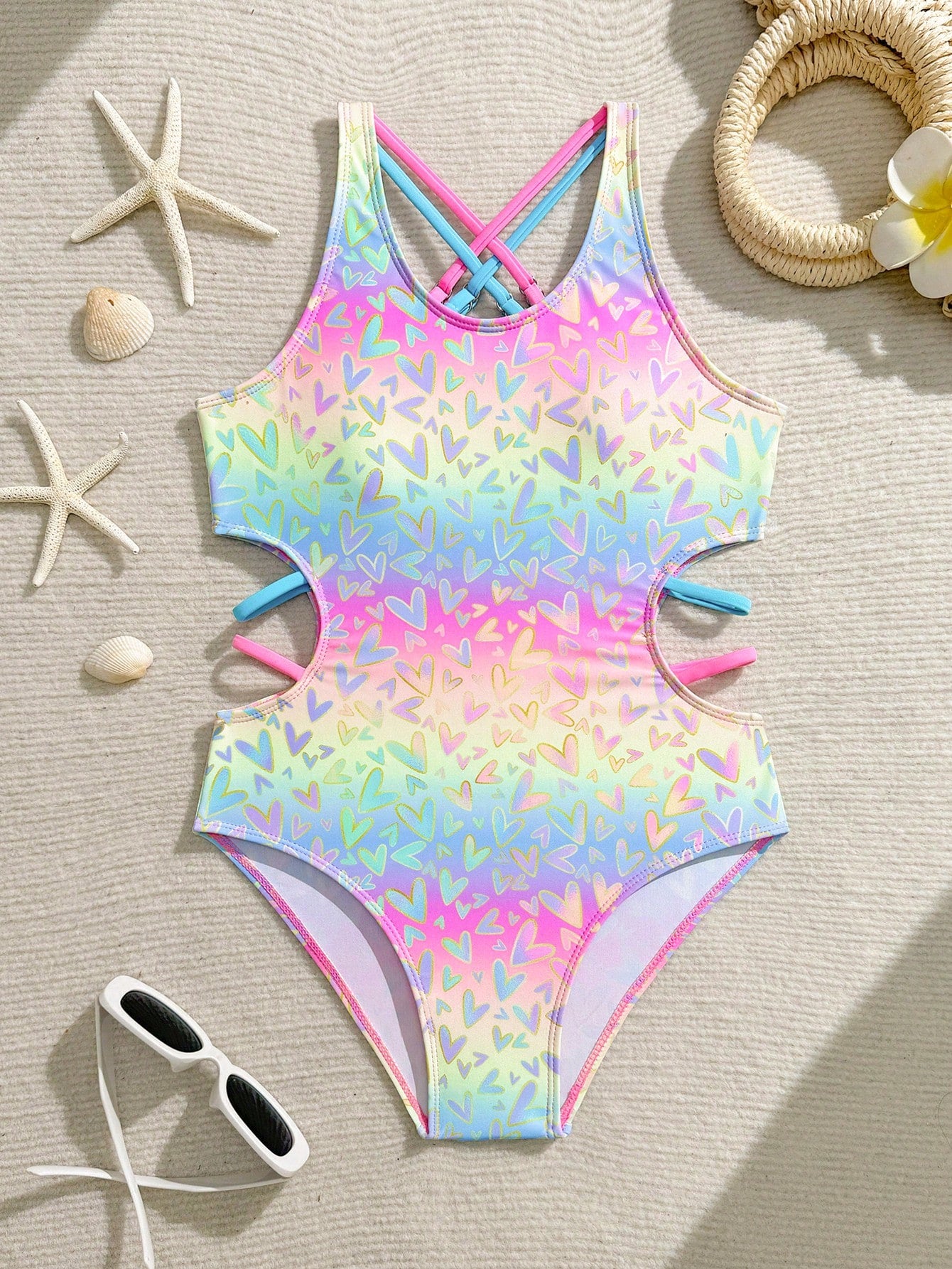 Tween girl multicolor one-piece swimsuit with gradient heart graphic print, scoop neck, cutout detail, and fitted vacation beachwear style.