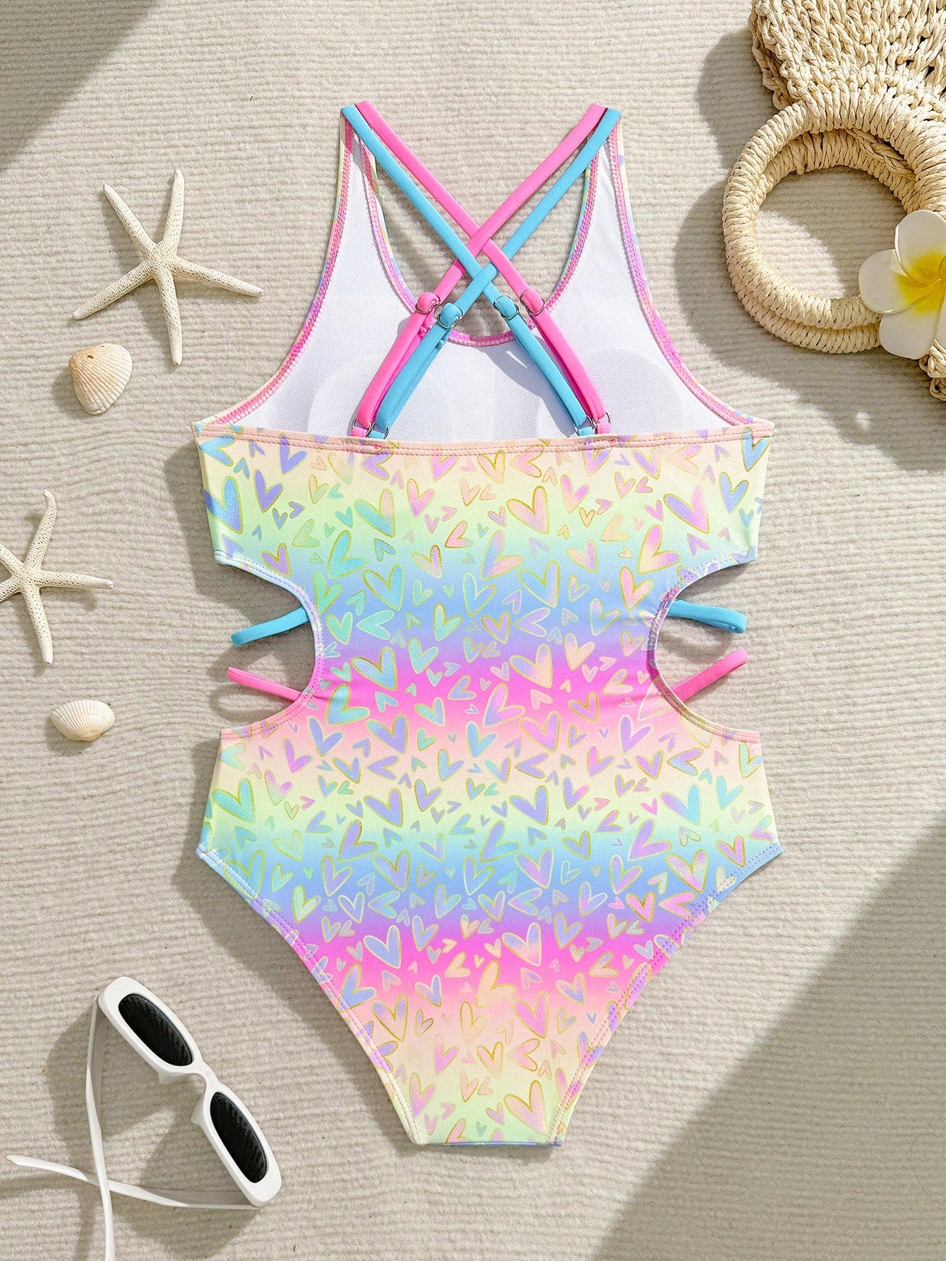 Tween girl multicolor one-piece swimsuit with gradient heart graphic print, scoop neck, cutout detail, and fitted vacation beachwear style.