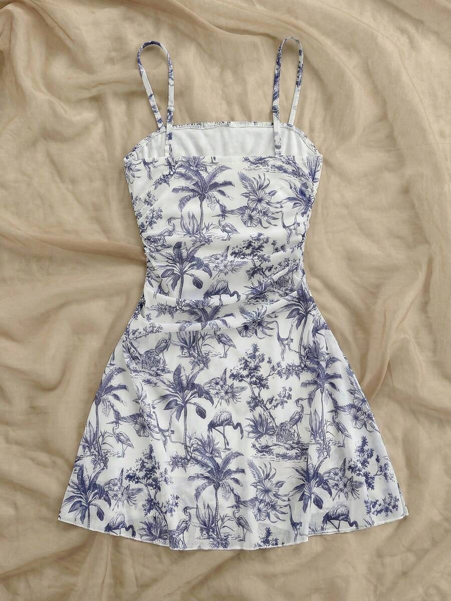 Tween girl yellow mini sundress with large pink floral hibiscus print, spaghetti straps, high waist, flared hem, and sleeveless cami style for summer beach wear
