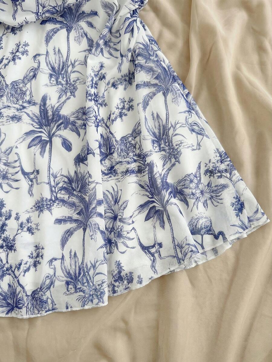 Tween girl yellow mini sundress with large pink floral hibiscus print, spaghetti straps, high waist, flared hem, and sleeveless cami style for summer beach wear