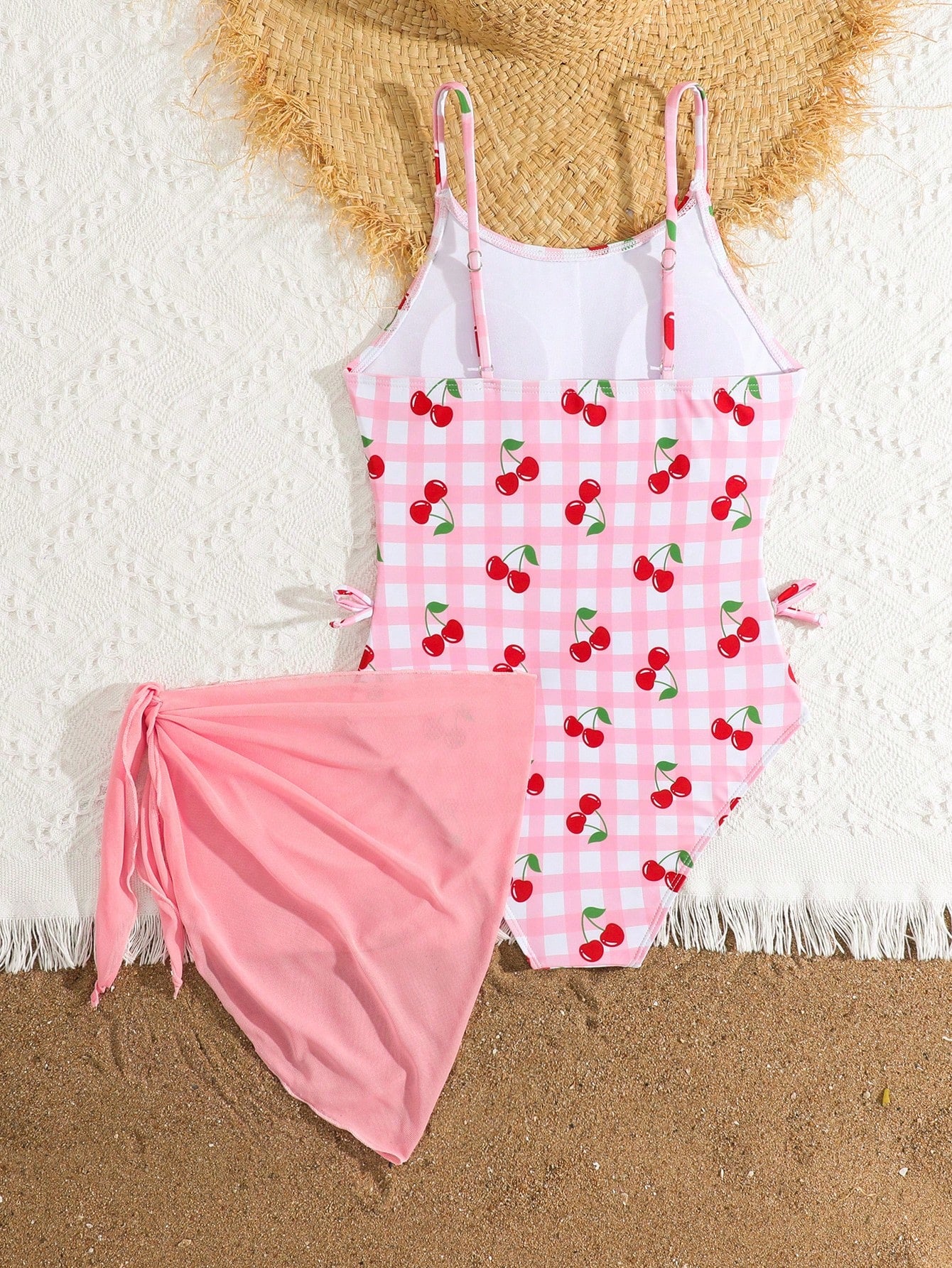 Tween girls 2-piece swimsuit in black with pink floral print, featuring spaghetti straps, bow decor, mesh detail, and a skirted mid-waist bottom. Sleeveless vacation-style swim set with medium-stretch fabric.
