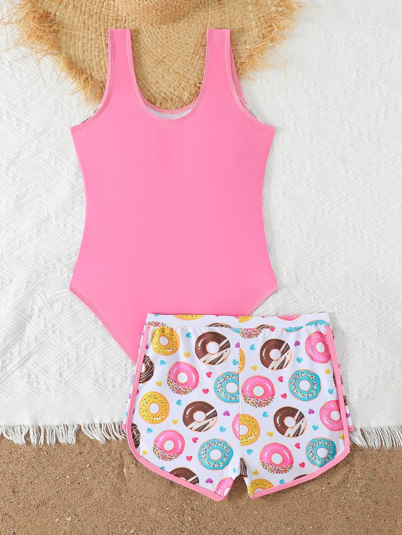 Tween girls 2-piece swimsuit set in black with full floral and plant print, featuring a sleeveless scoop-neck swim top and matching shorts-style bottoms.