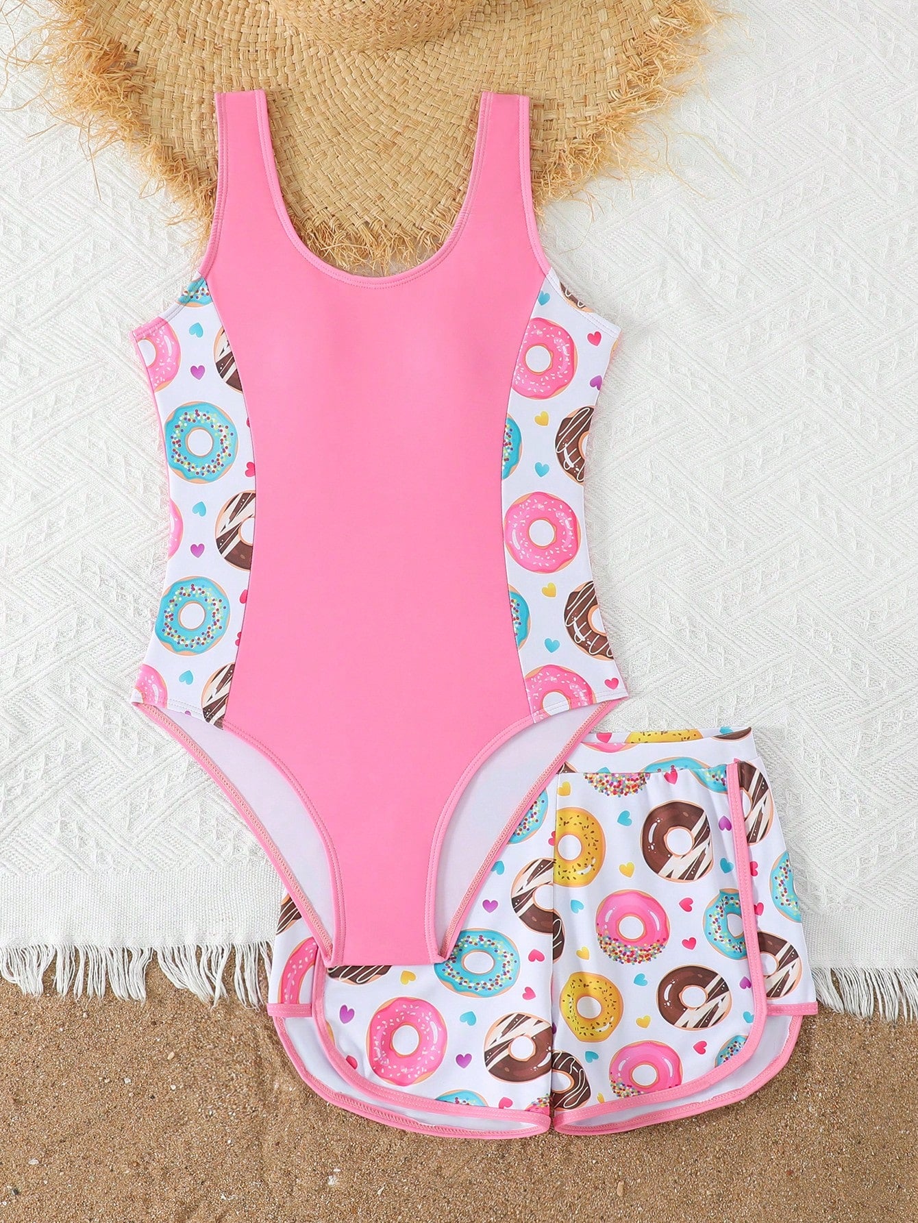 Tween girls 2-piece swimsuit set in black with full floral and plant print, featuring a sleeveless scoop-neck swim top and matching shorts-style bottoms.