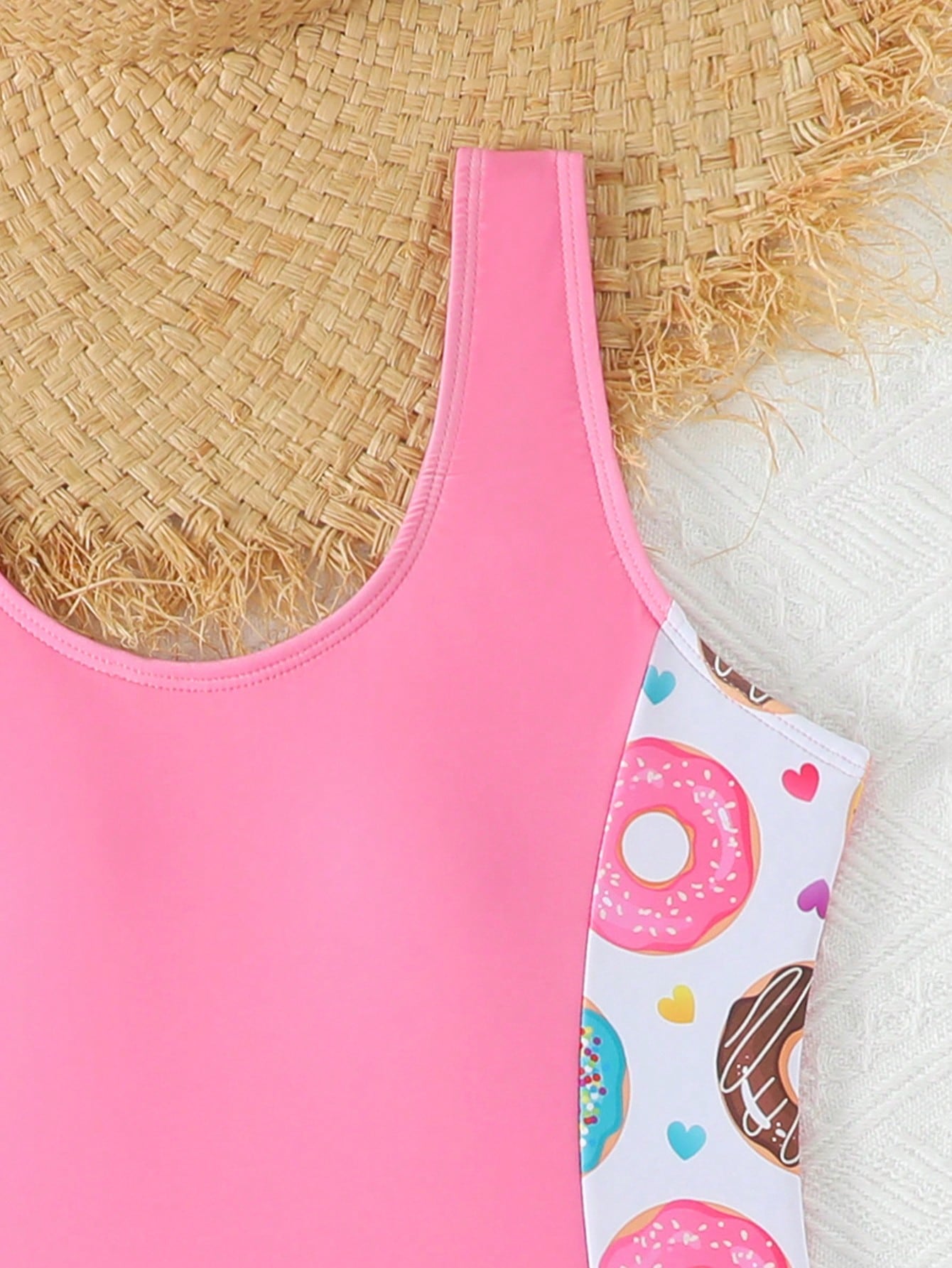 Tween girls 2-piece swimsuit set in black with full floral and plant print, featuring a sleeveless scoop-neck swim top and matching shorts-style bottoms.