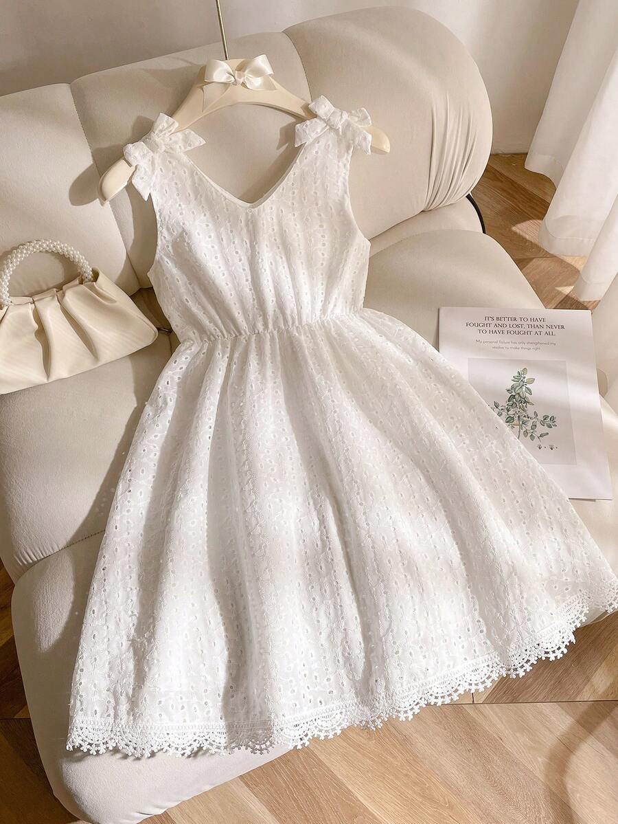 Girls sleeveless blue tiered dress featuring a V-neckline, high waist, and A-line skirt.
