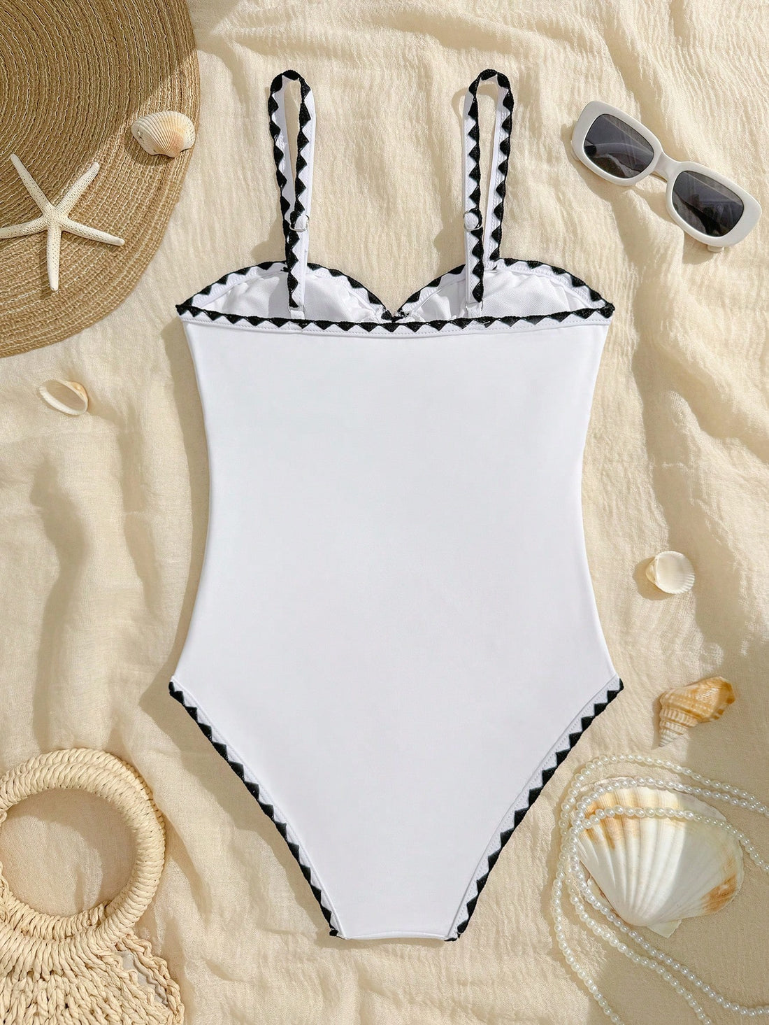White one-piece swimsuit for tween girls with spaghetti straps, cut-out detail, plain design, and medium-stretch swimsuit fabric for beach, pool, and vacation wear.