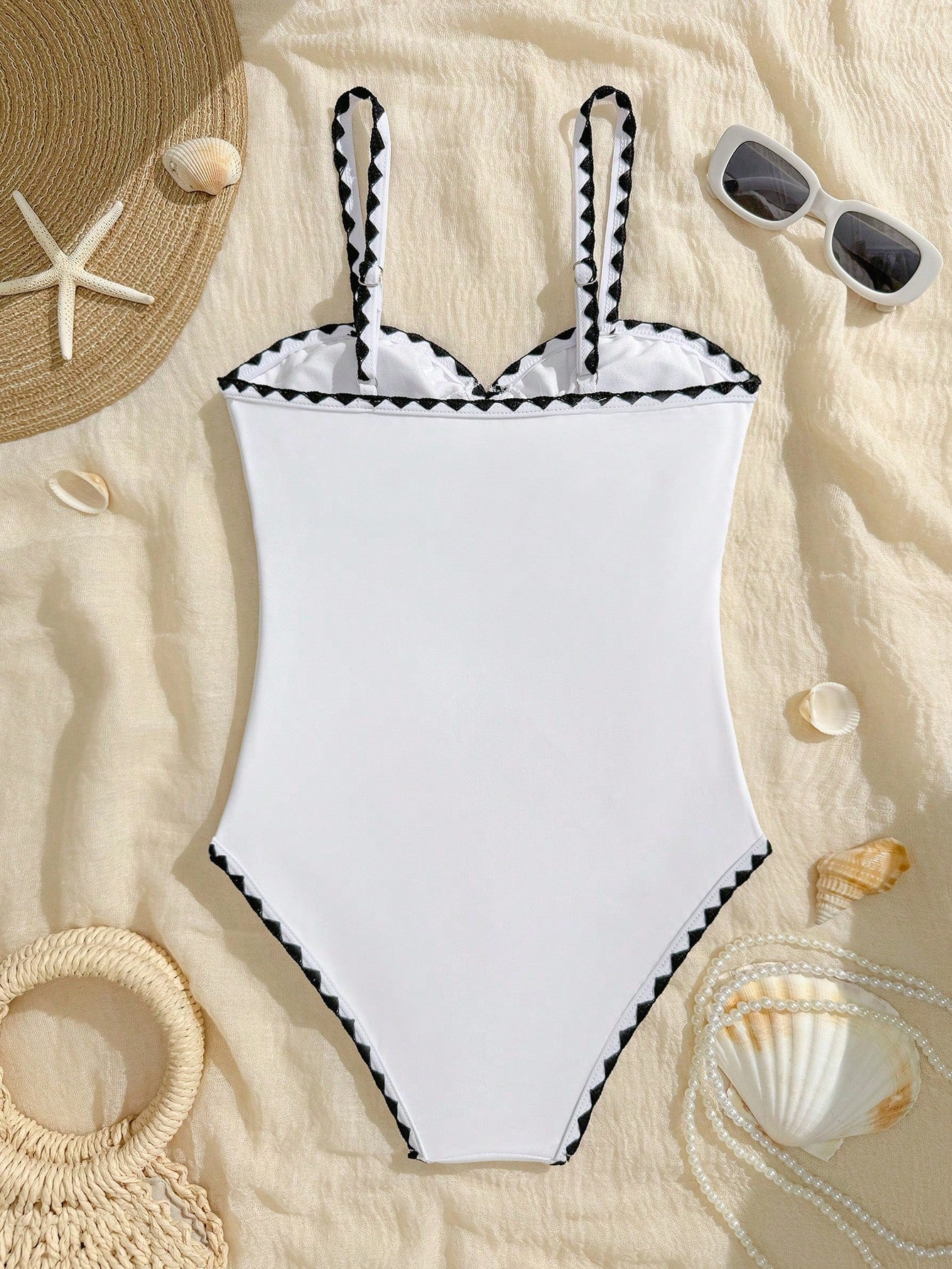 White one-piece swimsuit for tween girls with spaghetti straps, cut-out detail, plain design, and medium-stretch swimsuit fabric for beach, pool, and vacation wear.
