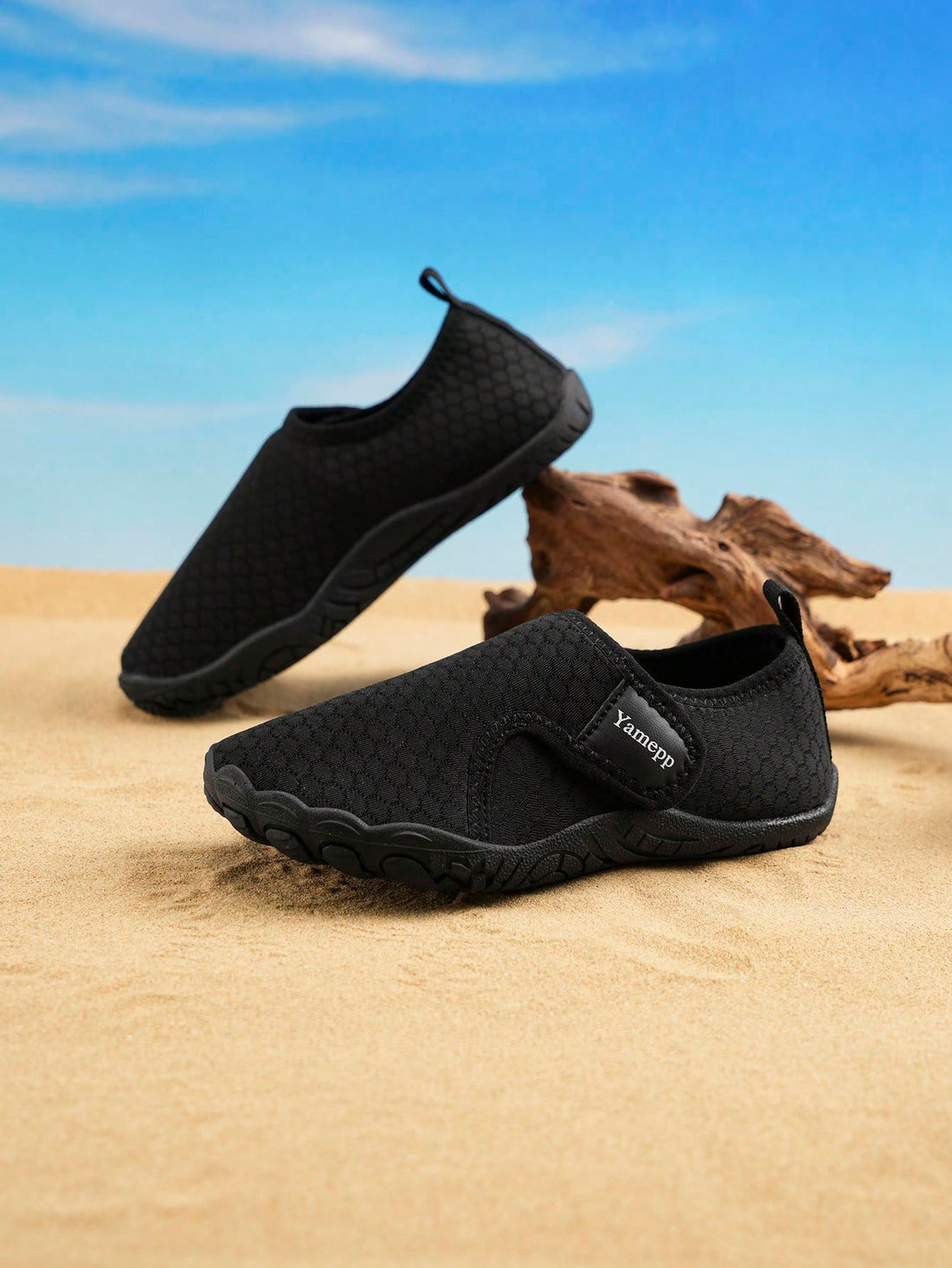 Black low-top kids water shoes featuring a breathable fabric upper, hook and loop closure, and rubber outsole for boys and girls.
