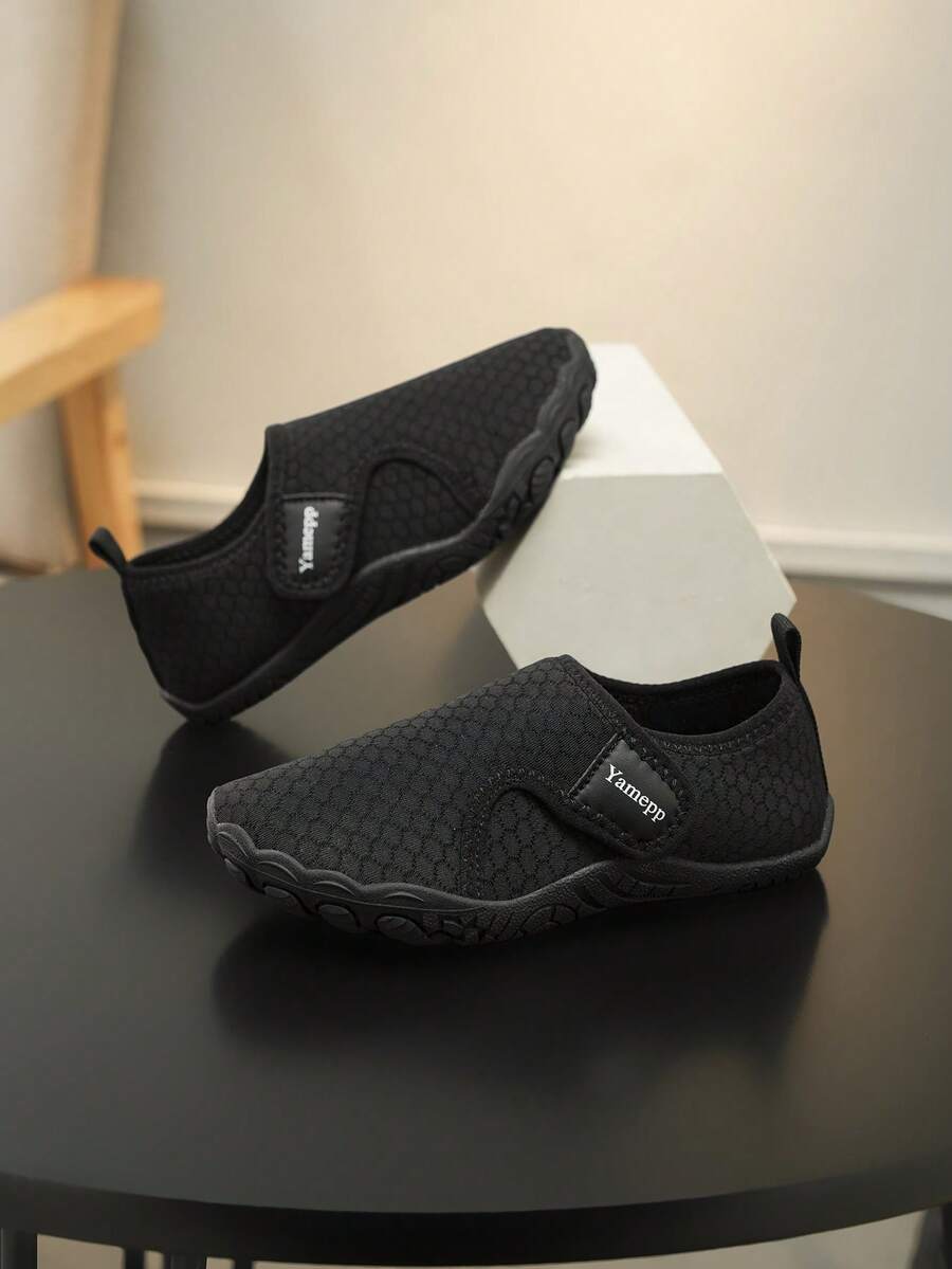Kids breathable mesh water shoes with hook and loop closure and durable rubber outsole.