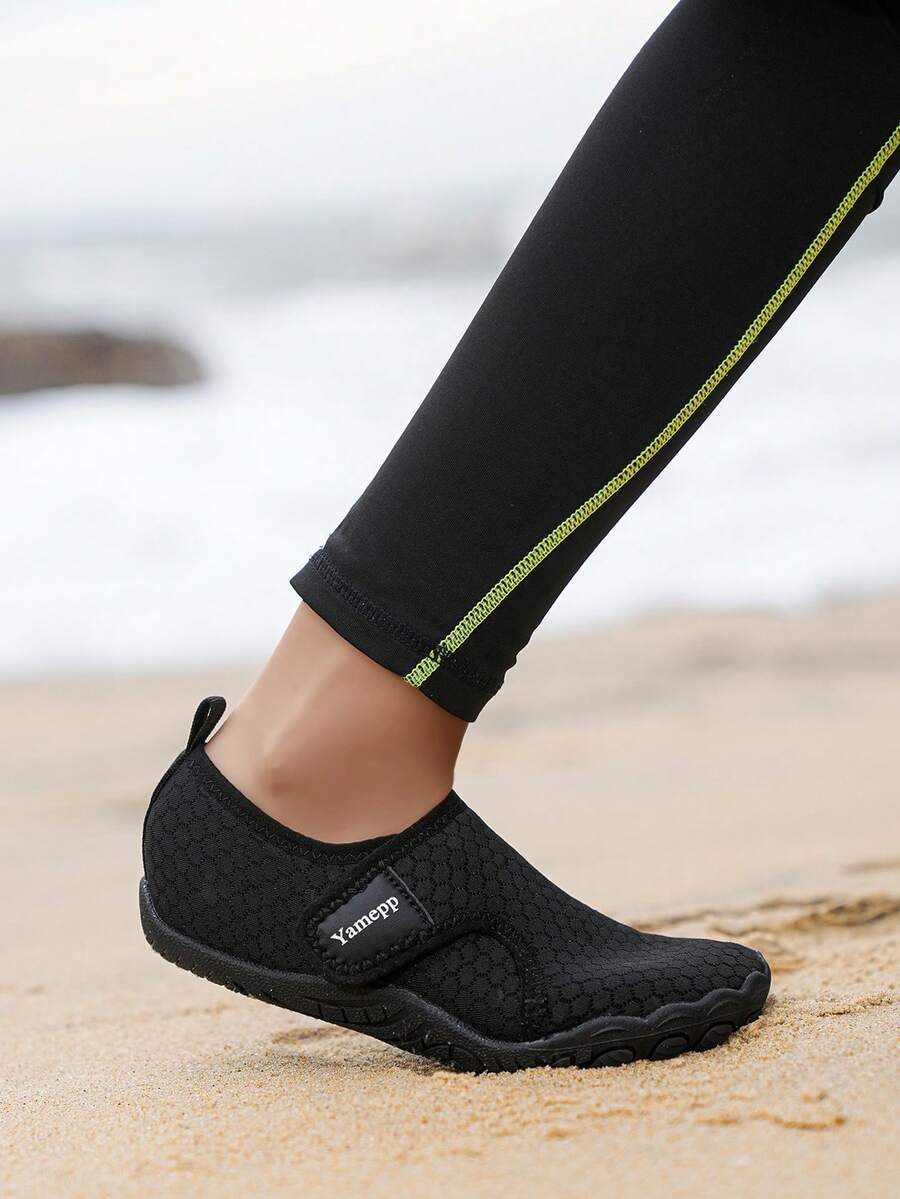 Kids breathable mesh water shoes with hook and loop closure and durable rubber outsole.