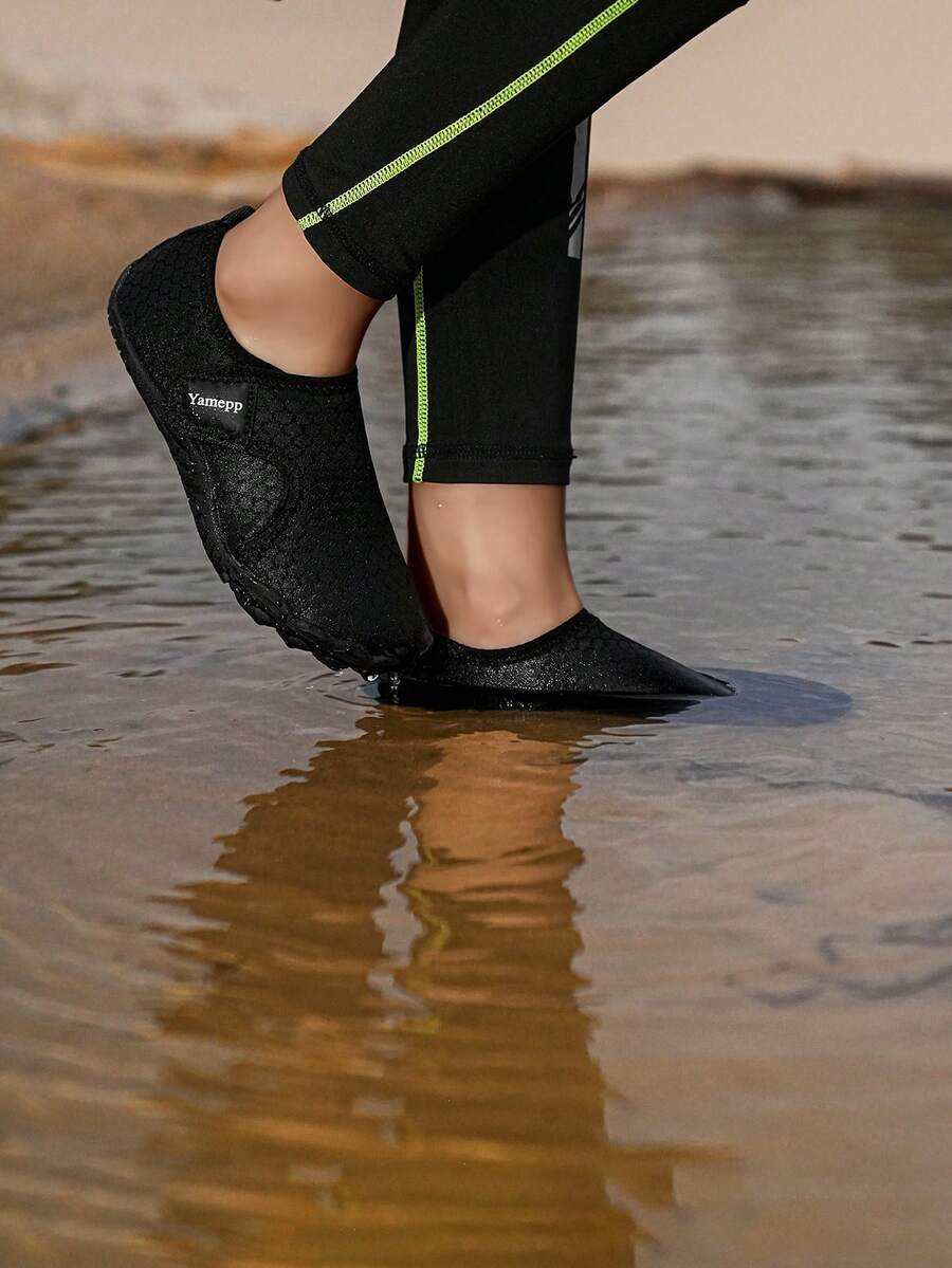 Kids breathable mesh water shoes with hook and loop closure and durable rubber outsole.