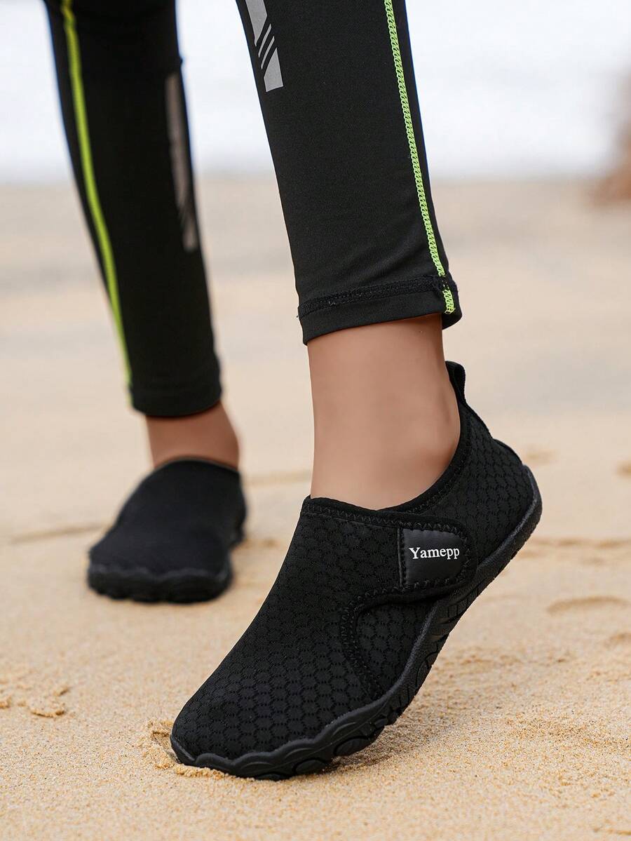 Kids breathable mesh water shoes with hook and loop closure and durable rubber outsole.