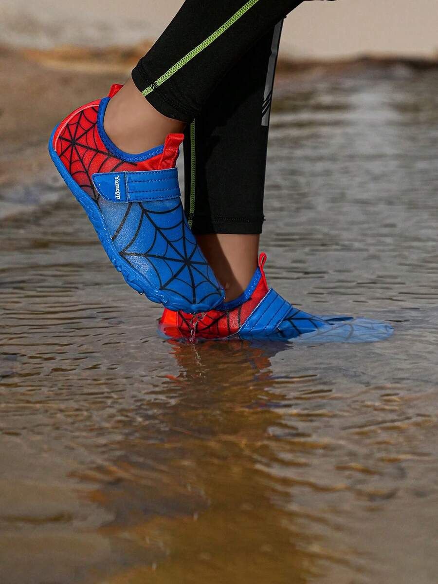 Pair of boys blue water shoes featuring a spider web mesh design, hook and loop strap, and non-slip rubber outsole.