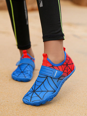 Pair of boys blue water shoes featuring a spider web mesh design, hook and loop strap, and non-slip rubber outsole.