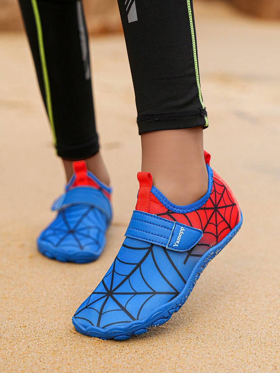 Pair of boys blue water shoes featuring a spider web mesh design, hook and loop strap, and non-slip rubber outsole.