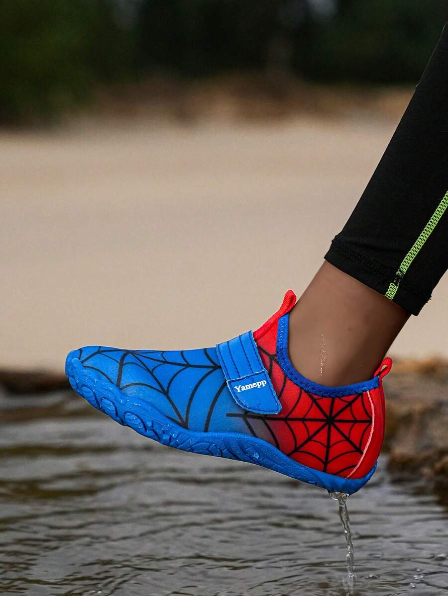 Pair of boys blue water shoes featuring a spider web mesh design, hook and loop strap, and non-slip rubber outsole.