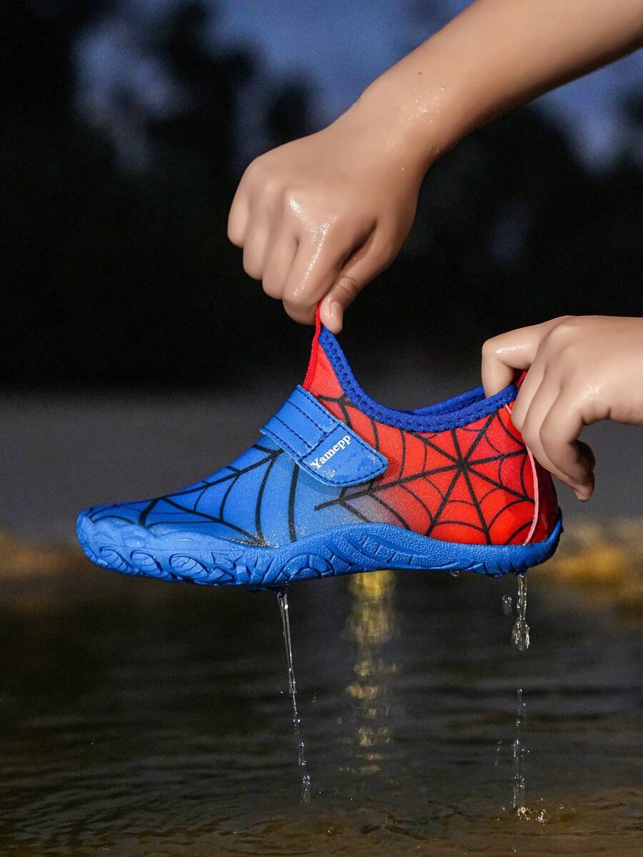 Pair of boys blue water shoes featuring a spider web mesh design, hook and loop strap, and non-slip rubber outsole.
