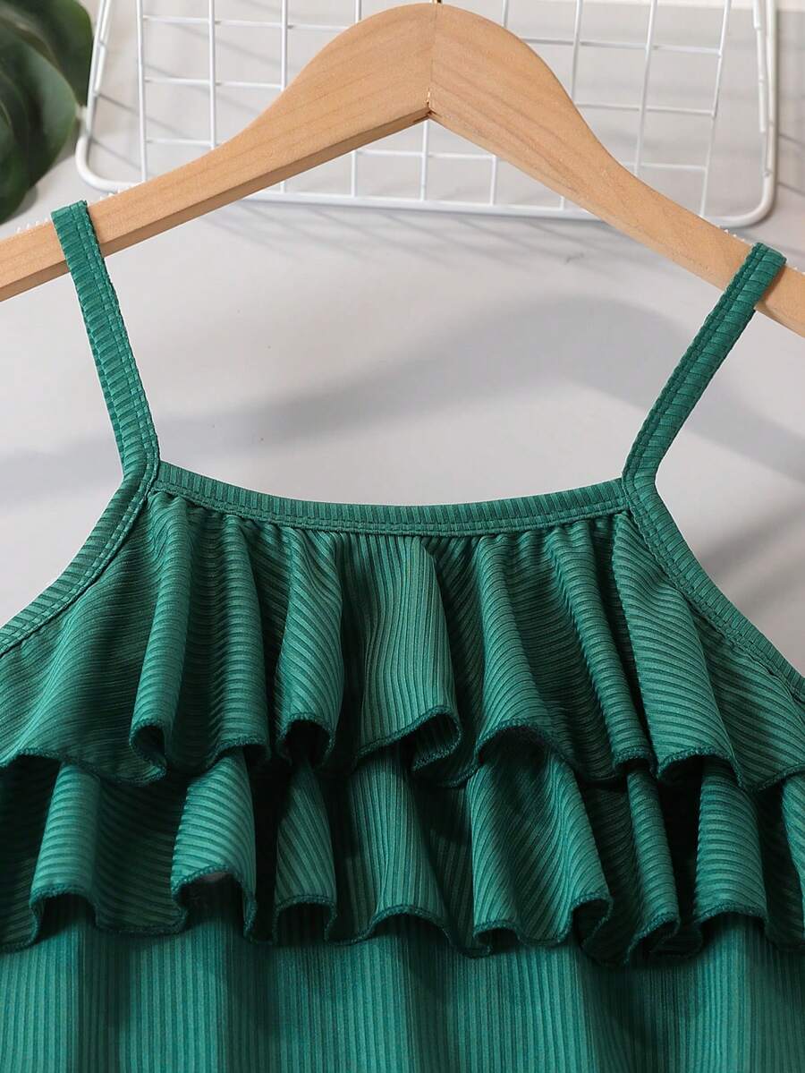 Tween girls blue 2-piece vacation outfit set featuring a tiered ruffle spaghetti strap camisole and loose high-waist pants.