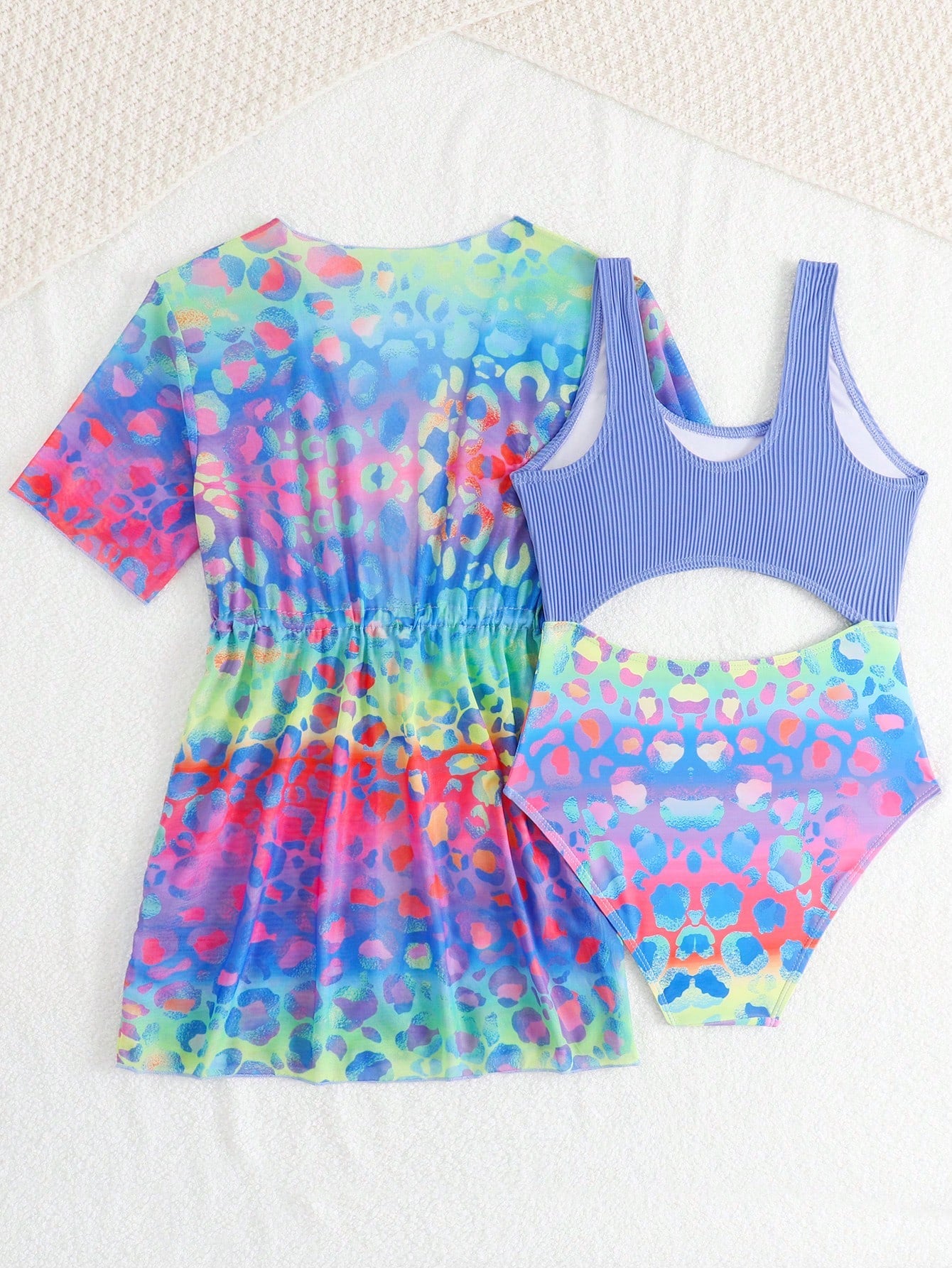 Tween girls multicolor 2-piece swimsuit set with scoop neck, cut-out details, patterned design, shorts-style bottoms, and sheer UV protection cover-up for beach and pool vacations.