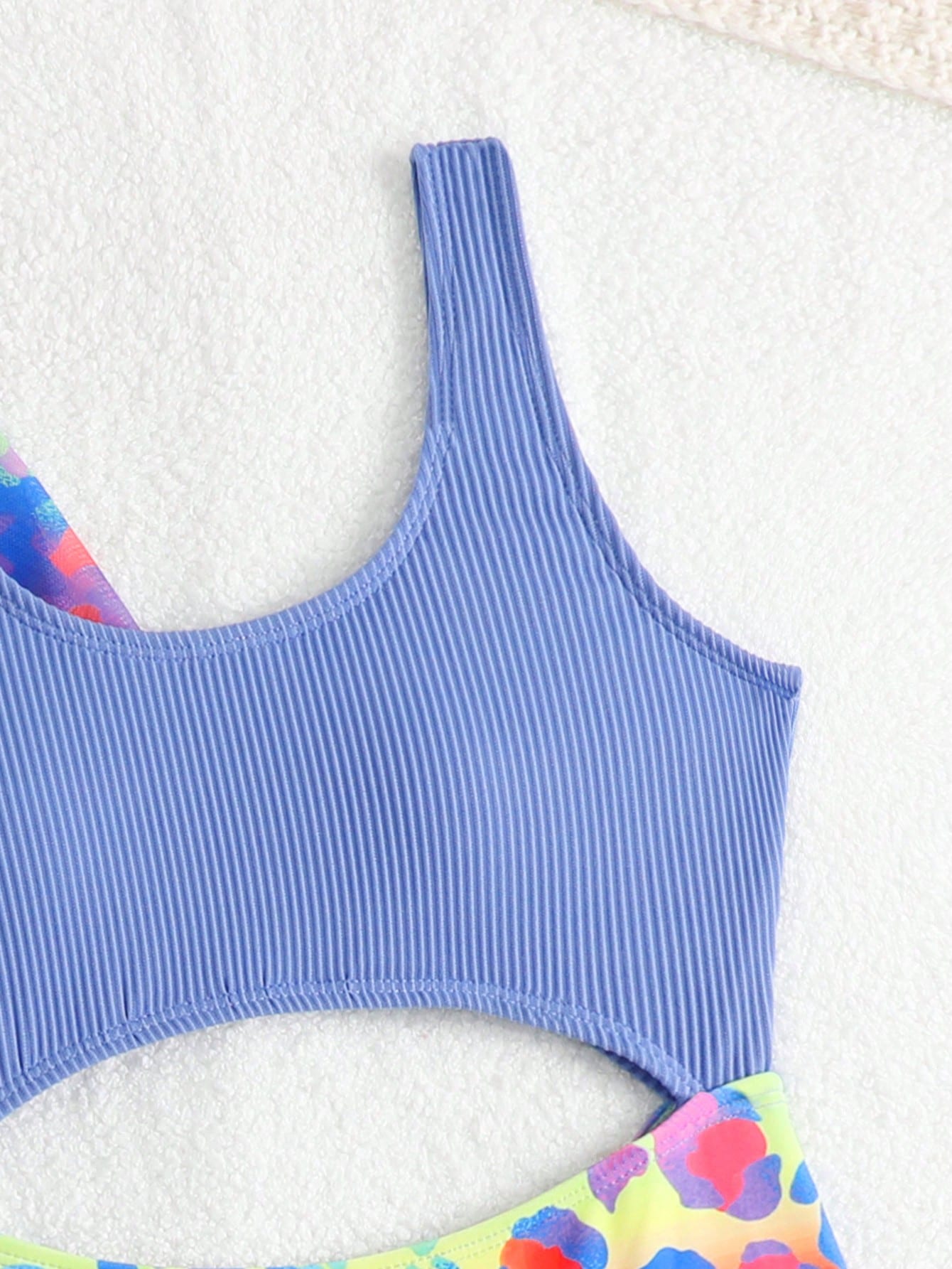 Tween girls multicolor 2-piece swimsuit set with scoop neck, cut-out details, patterned design, shorts-style bottoms, and sheer UV protection cover-up for beach and pool vacations.